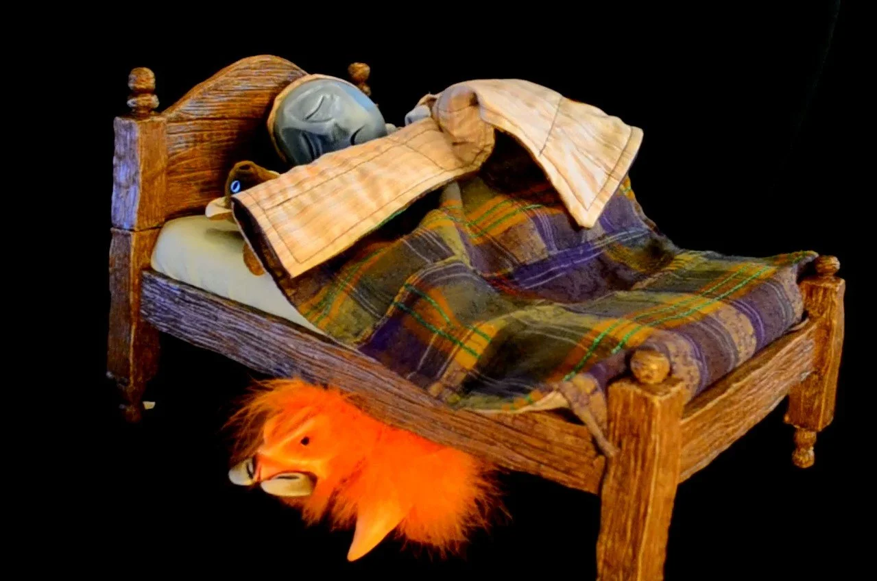 A monster crawls out from under the bed as the bed’s occupant sleeps.