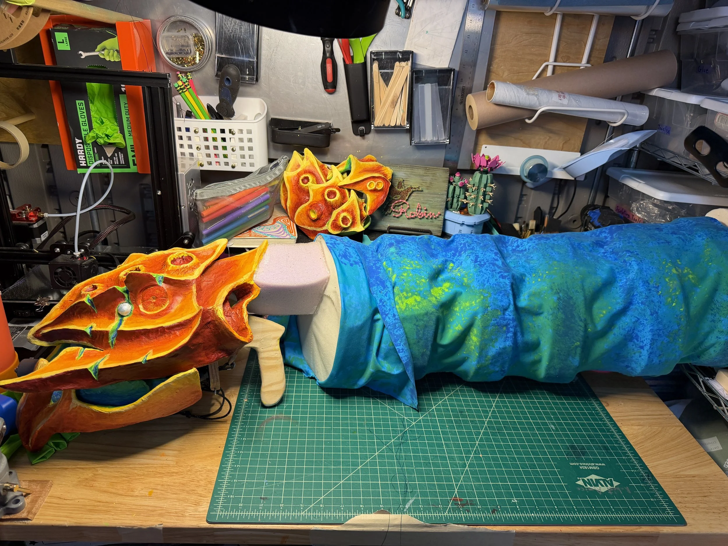 Robin Amico’s workbench is quickly taken over by puppets as she assembles the body of a giant apex alien! 