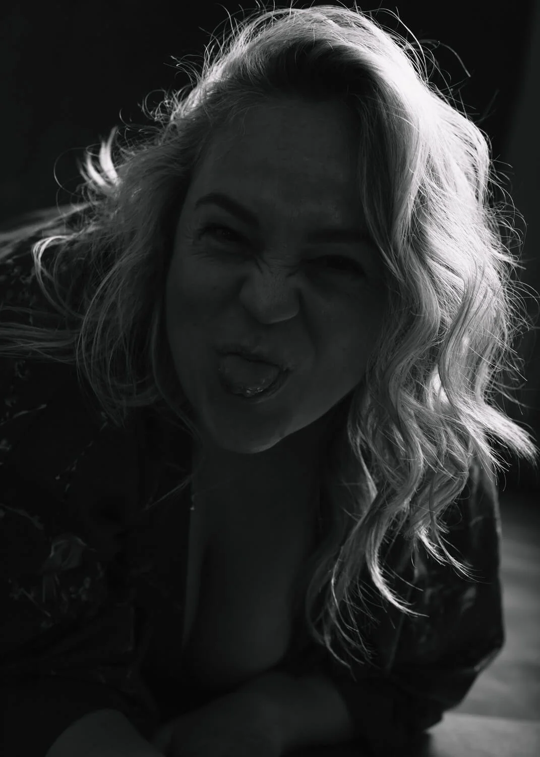 silhouette image of woman smiling and sticking out tongue