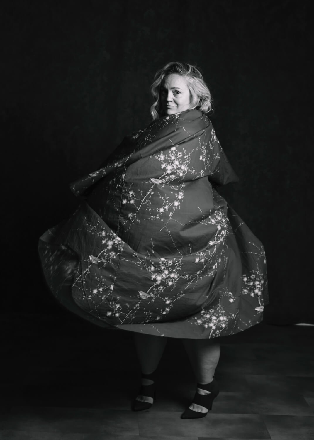 woman twirling in kimono in black and white image