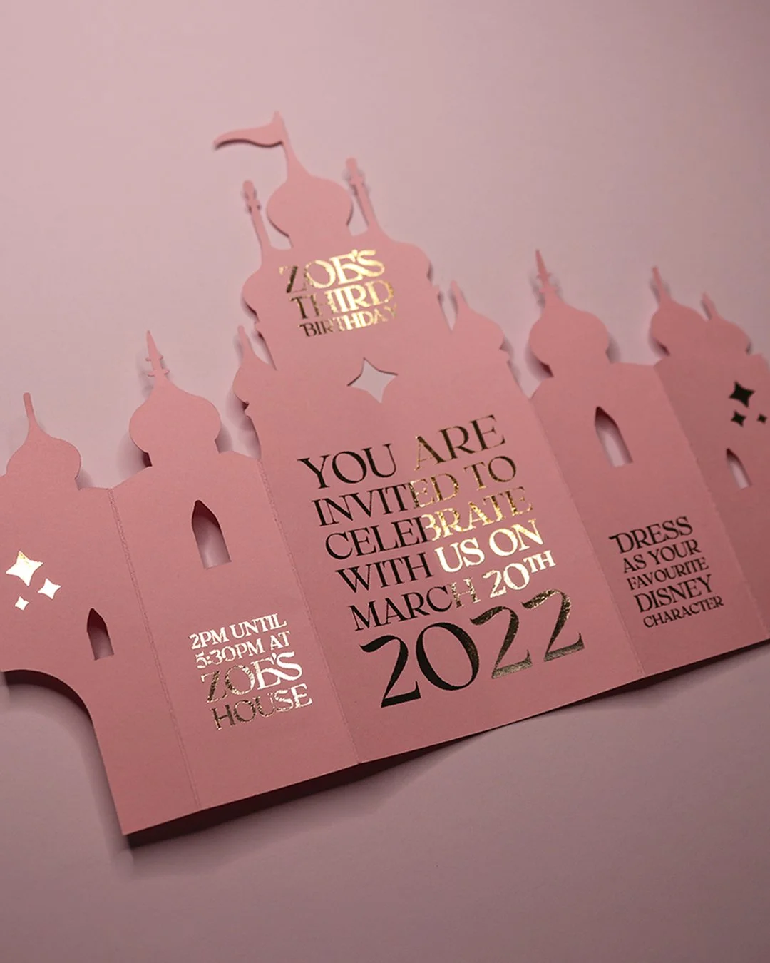 Kids Folding Castle Themed Birthday Invitation. Rose Gold Foil on Pink Card Stock Cut to Custom Shape of Fairytale Castle