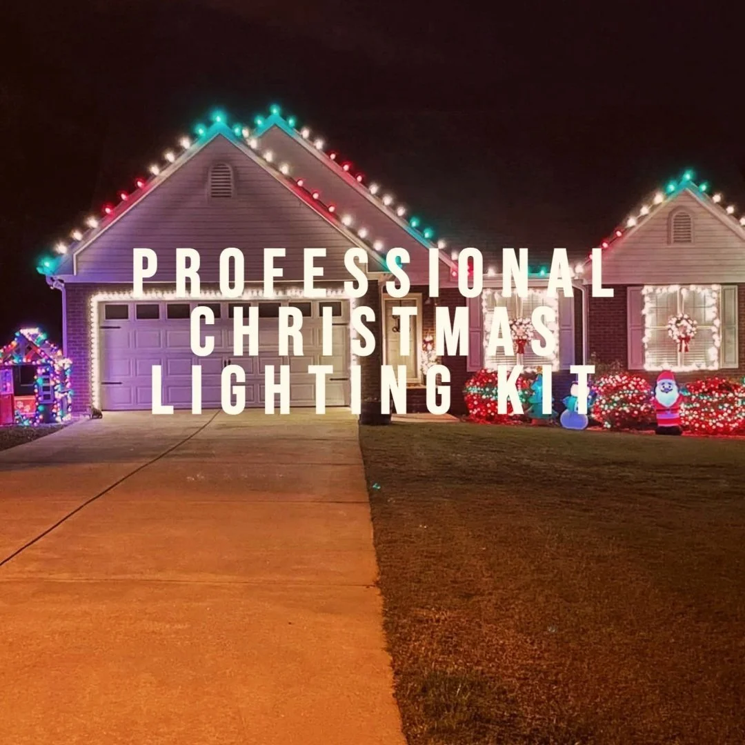 A house decorated with Christmas lights at night, including colorful lights outlining the roof, a wreath on the window, and Santa Claus and snowman inflatable decorations in the yard, with text overlay reading 'Professional Christmas Lighting Kit'.