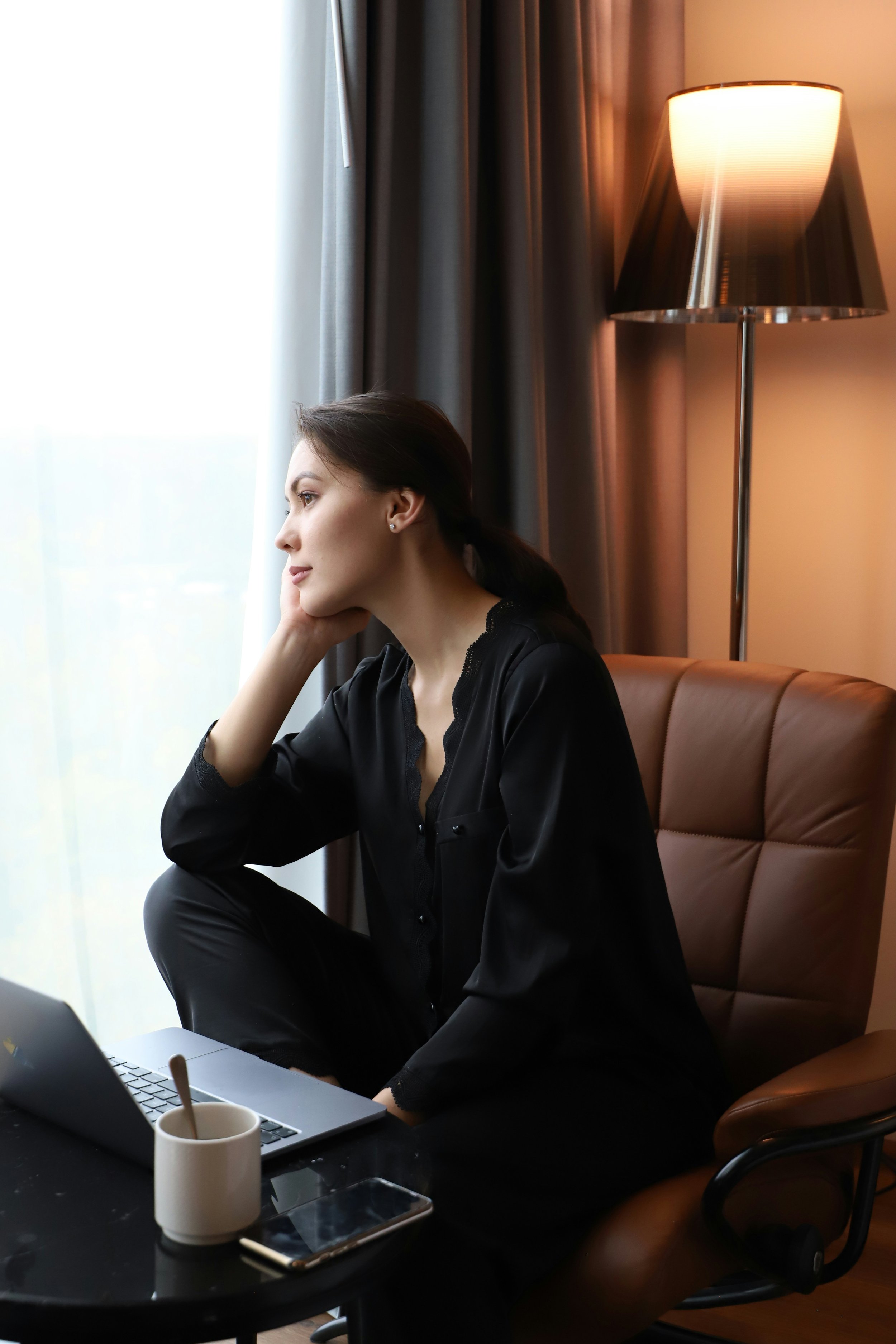 Professional pausing thoughtfully, representing how trauma and PTSD shows up in the lives of high-achieving adults seeking therapy in North Carolina