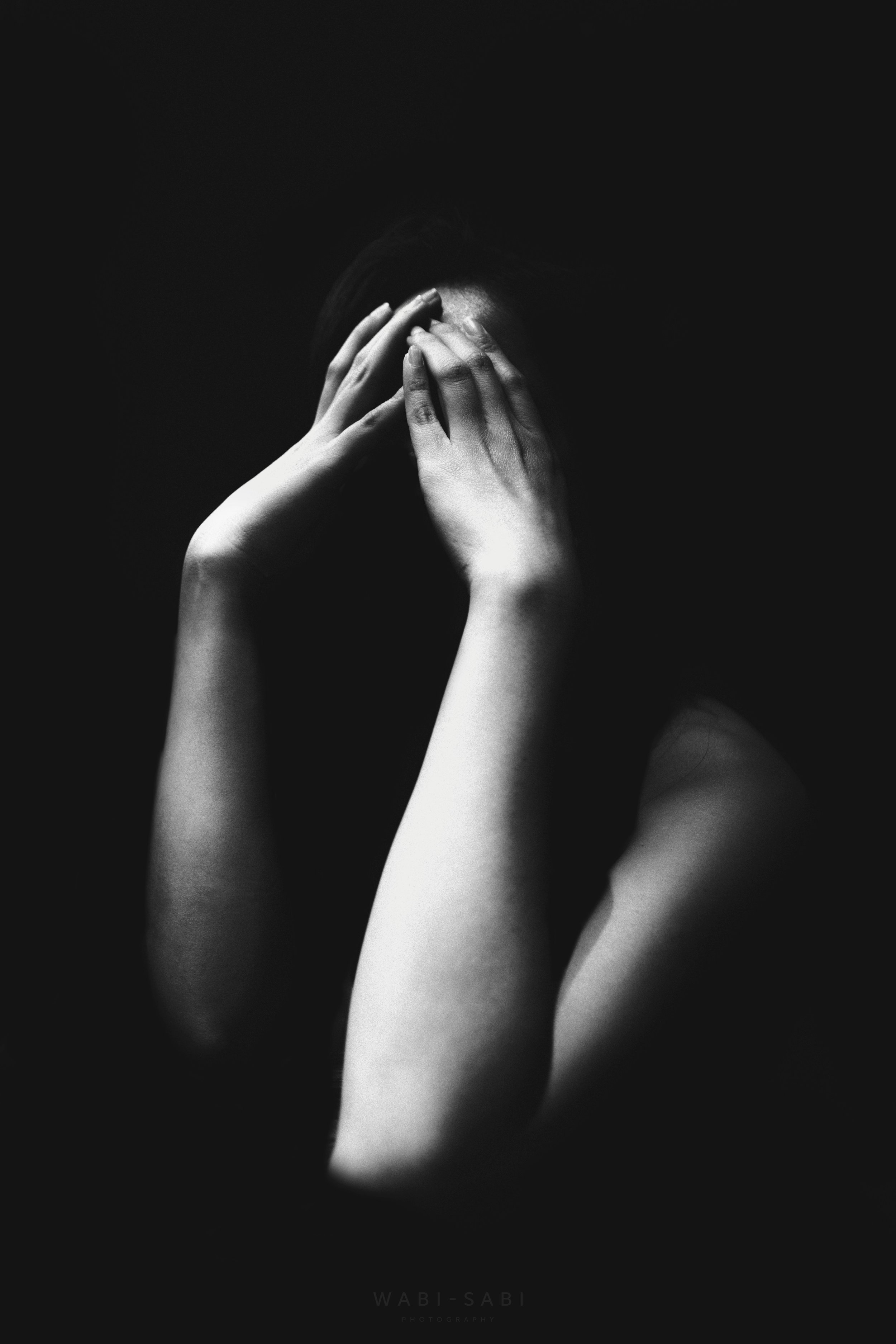 Person sitting quietly representing the internal experience of PTSD symptoms and the need for trauma therapy in North Carolina