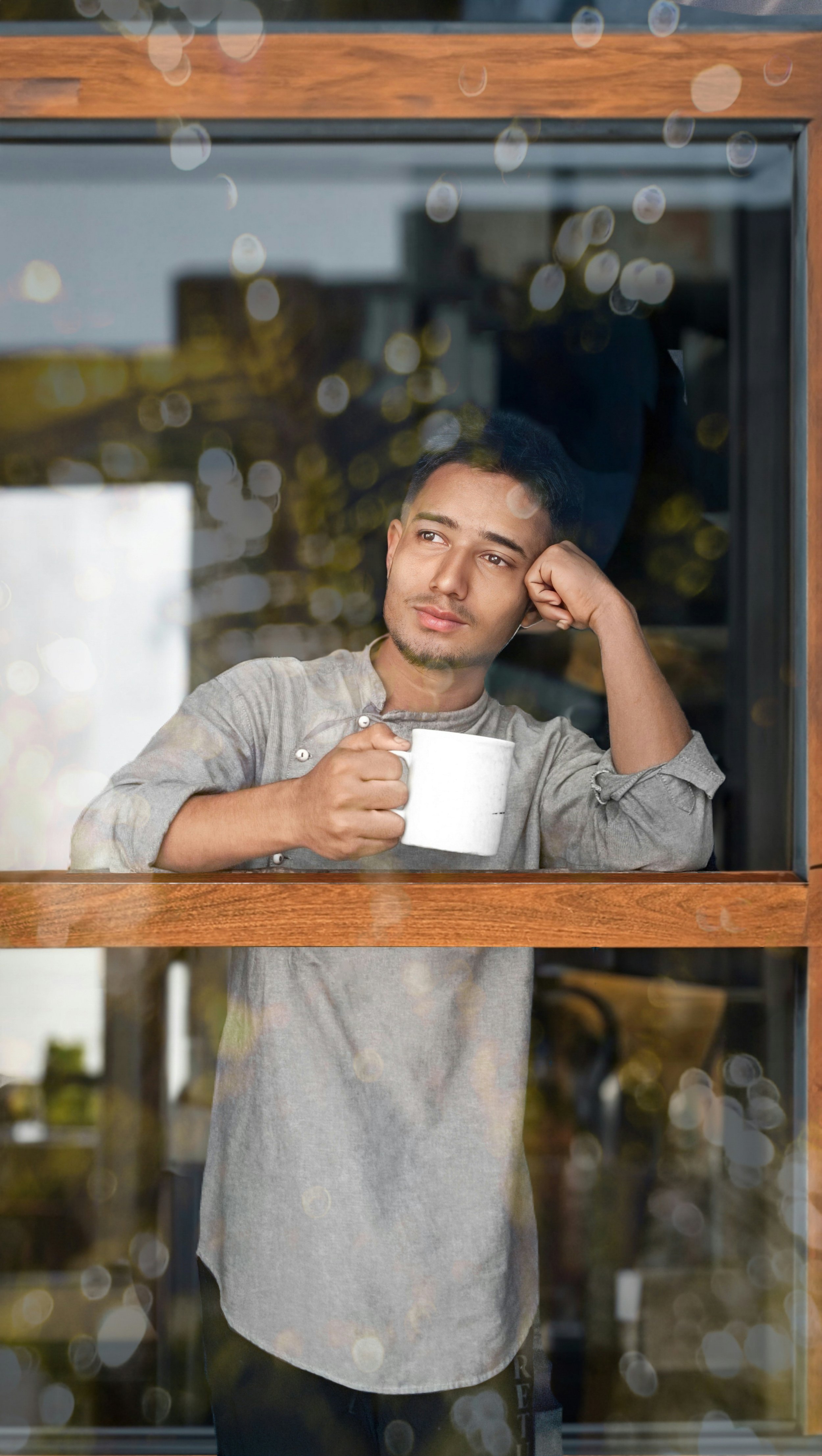 Person reflecting quietly, representing the personal and varied nature of trauma and the path toward PTSD therapy in North Carolina