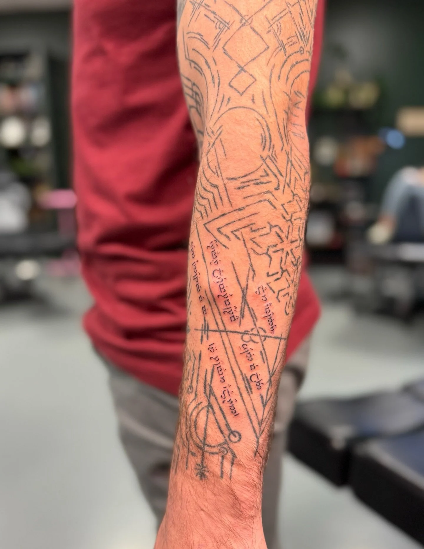 An abstract linework only sleeve in progress for Ryan, designed and tattooed by Marki. If you look closely, you can check out the Elvish script that they&rsquo;re starting to tuck in. Stay tuned to see more of that text develop throughout the sleeve 