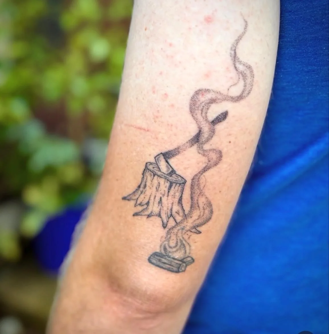 The newest work designed and tattooed by our apprentice, @sesleanyvall - this campfire scene was achieved one dot at a time and we are obsessed. She tattooed the logs and fire at one of our flash events and then designed the stump, axe, and smoke to 