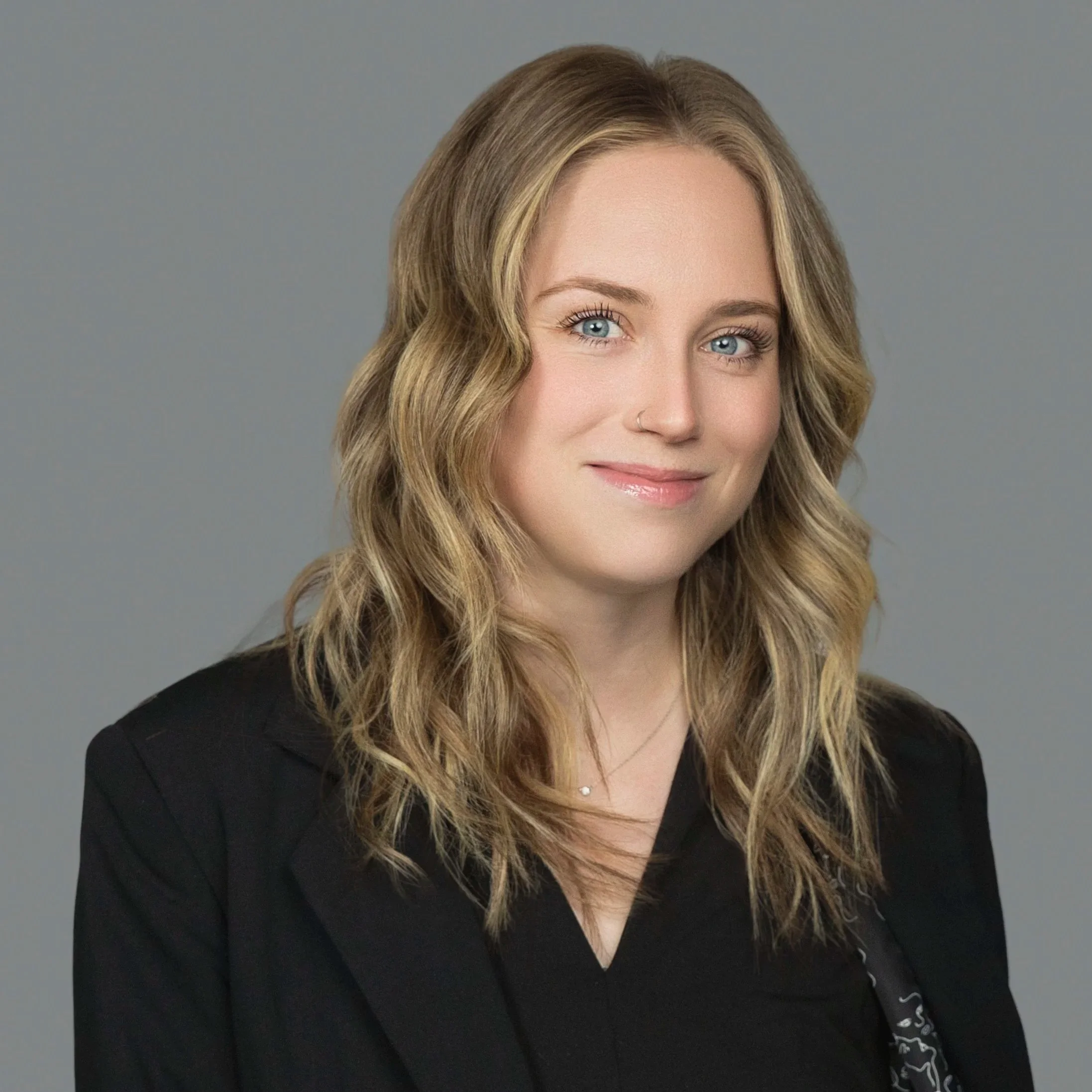 Studio headshot of a medical AI specialist in professional business attire for company website and healthcare technology marketing.