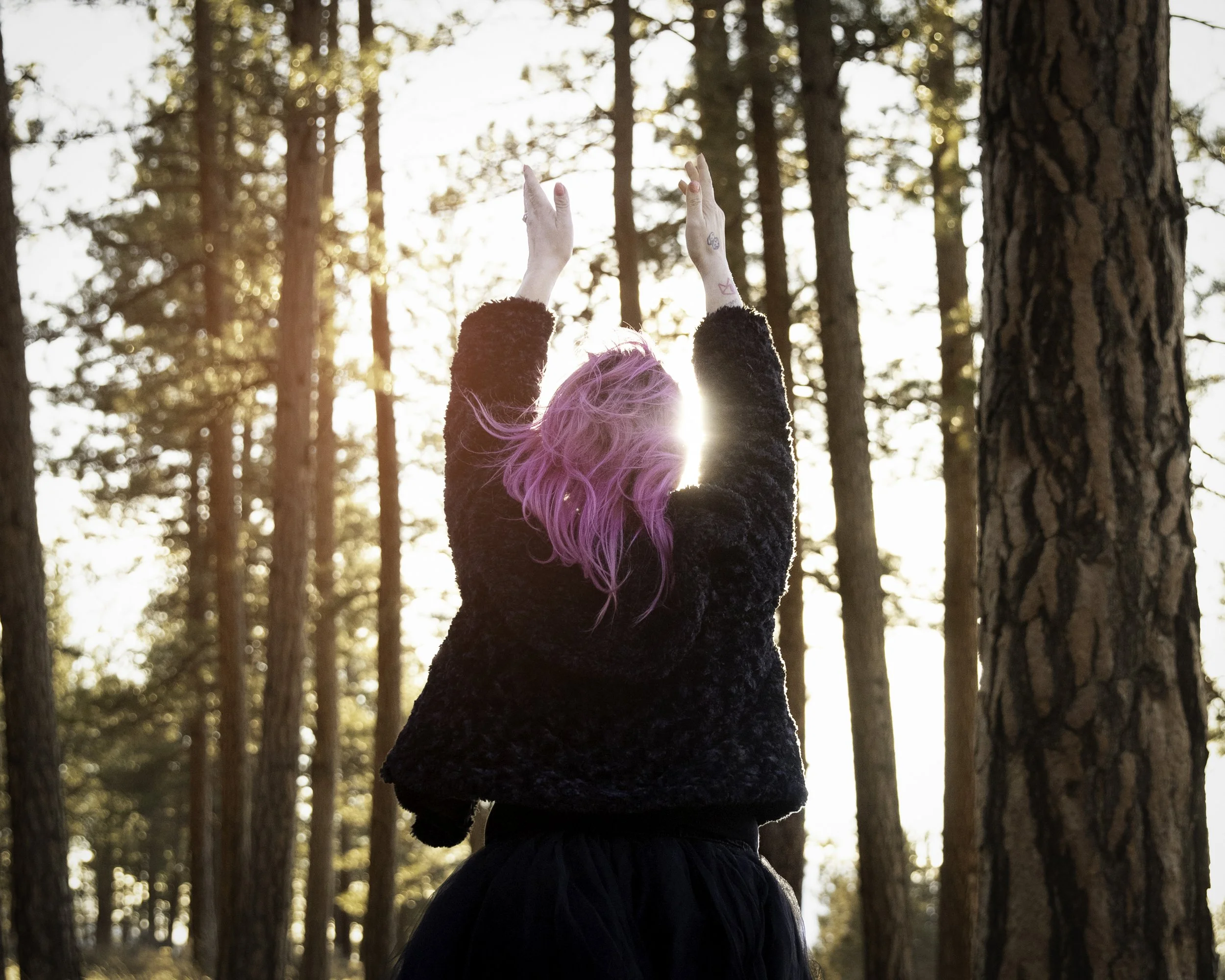 Personal coach embracing growth and transformation in nature for mindset and life coaching brand