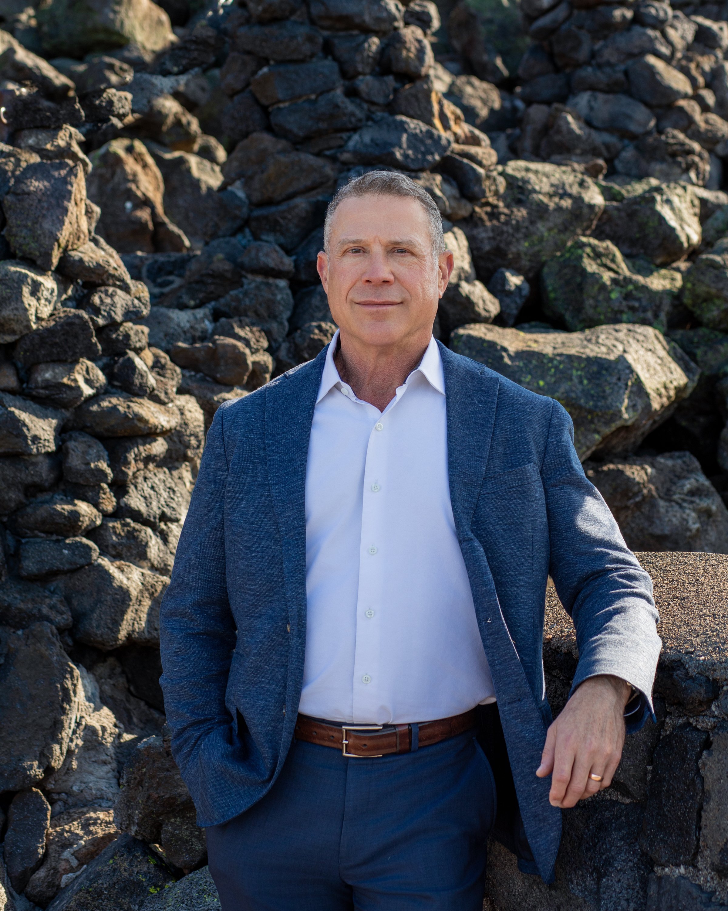 Professional headshot of attorney and business owner in Bend Oregon standing outdoors in a confident pose