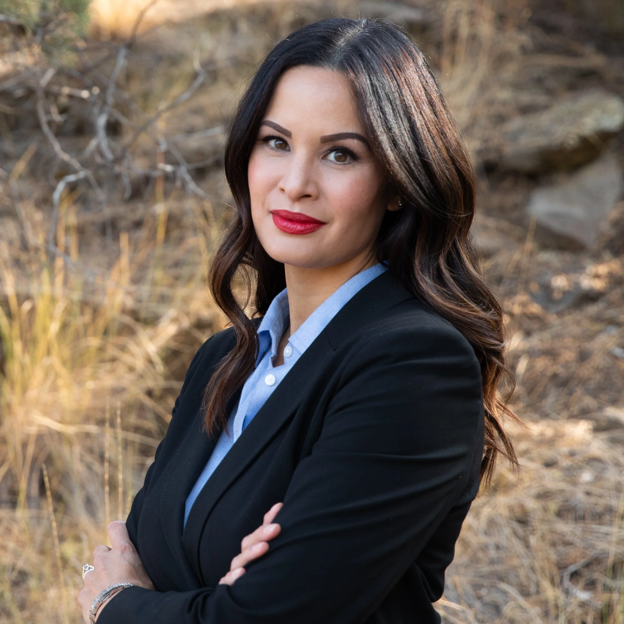 Professional headshot of real estate agent in Redmond Oregon with outdoor background and confident expression