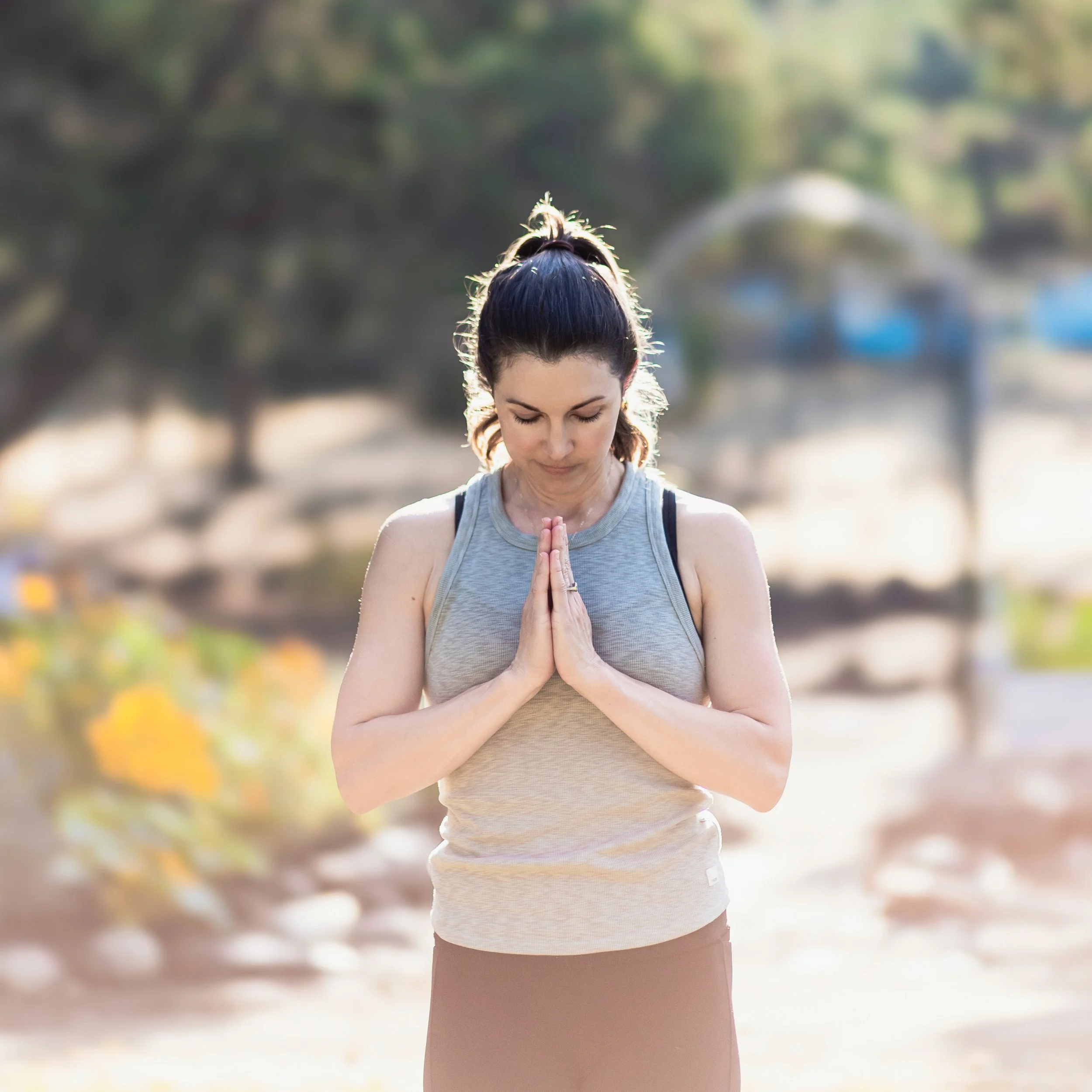 Female wellness entrepreneur practicing mindfulness and meditation outdoors for personal brand photography