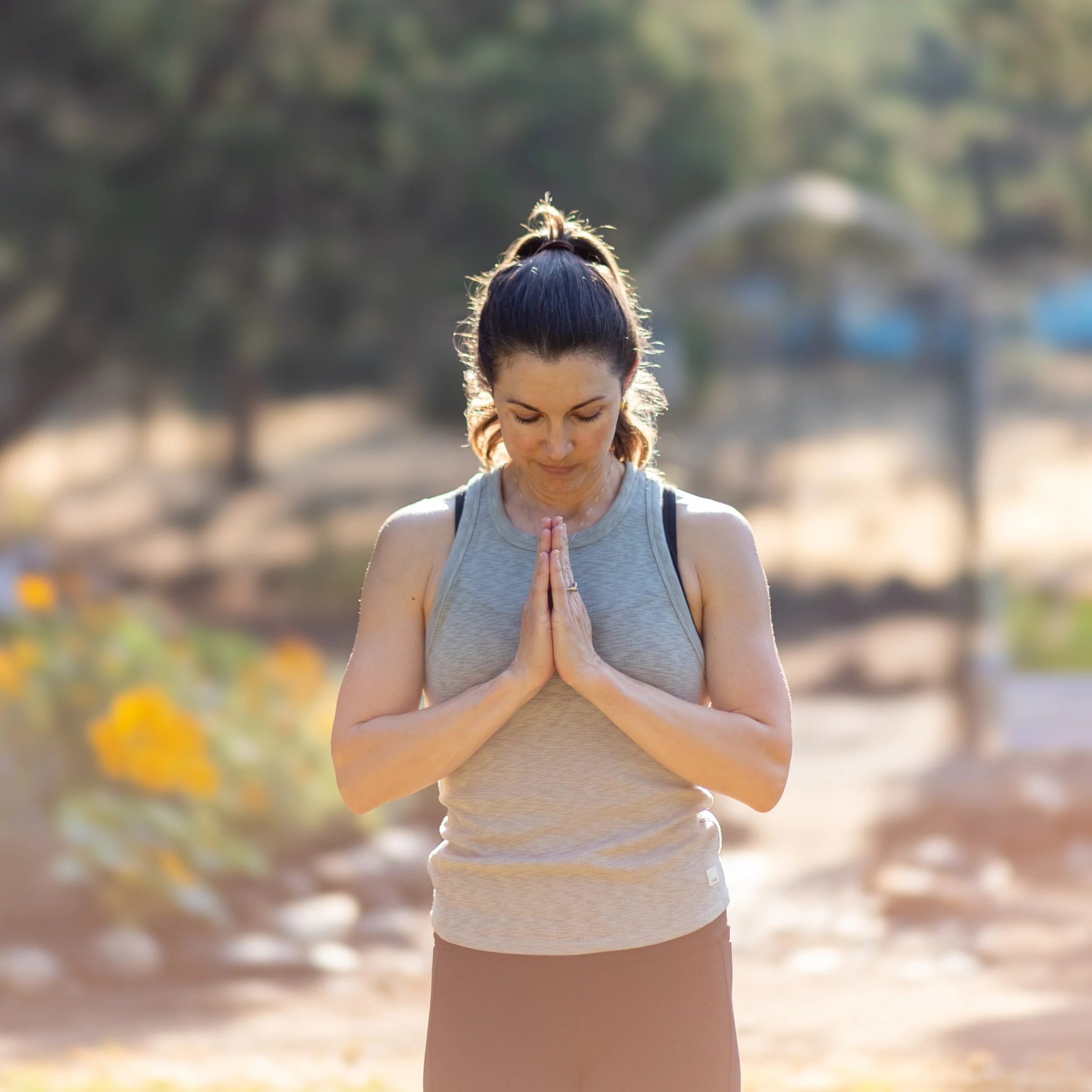 Woman practicing mindfulness and meditation outdoors during a wellness branding session for a holistic lifestyle.