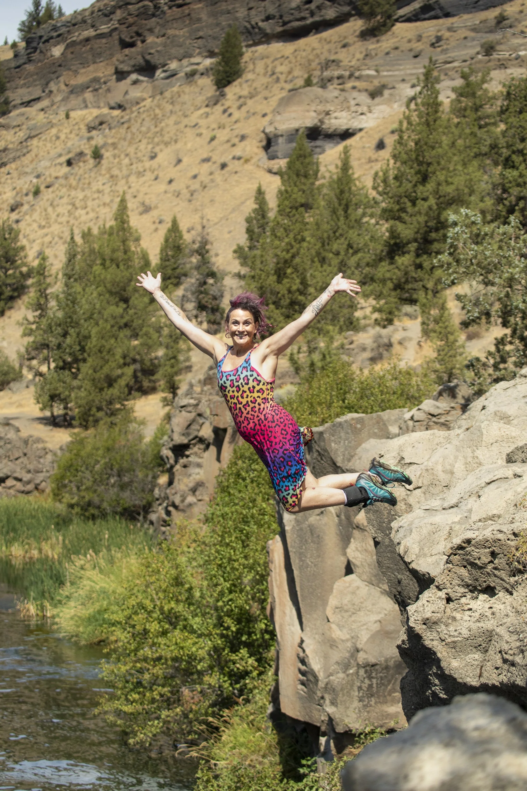 Empowered woman jumping outdoors symbolizing freedom, strength, and new life transformation coaching