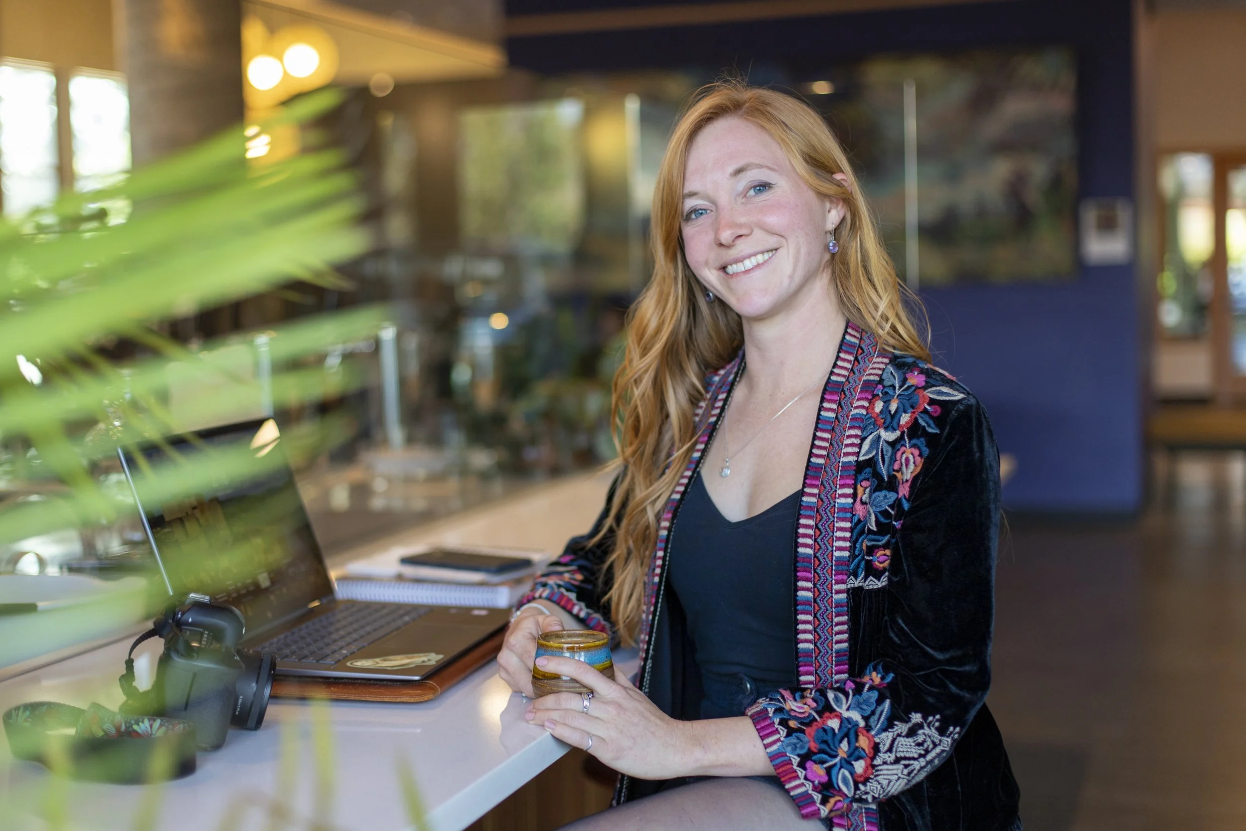Personal branding photo of graphic designer working on laptop in Bend Oregon with natural light and relaxed lifestyle setting