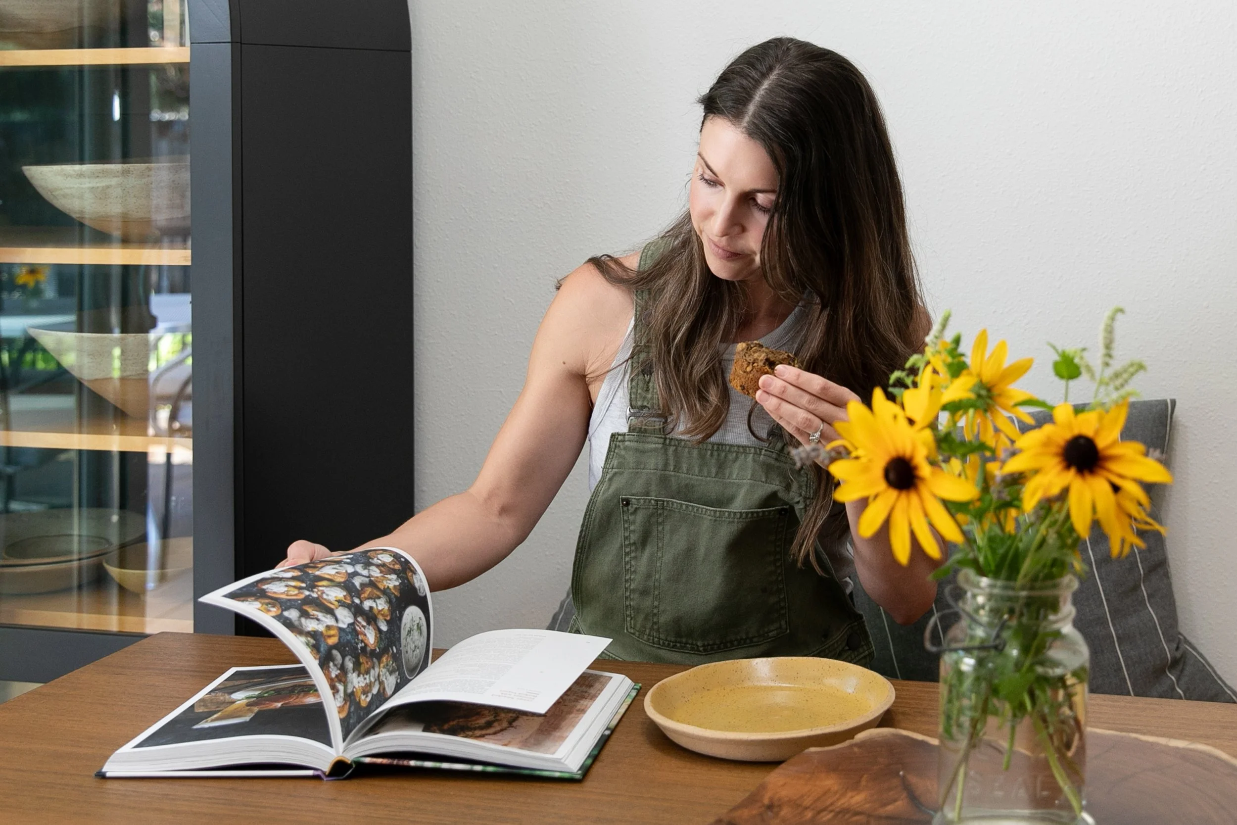 Female small business owner reviewing cookbook and preparing food for lifestyle brand content and marketing