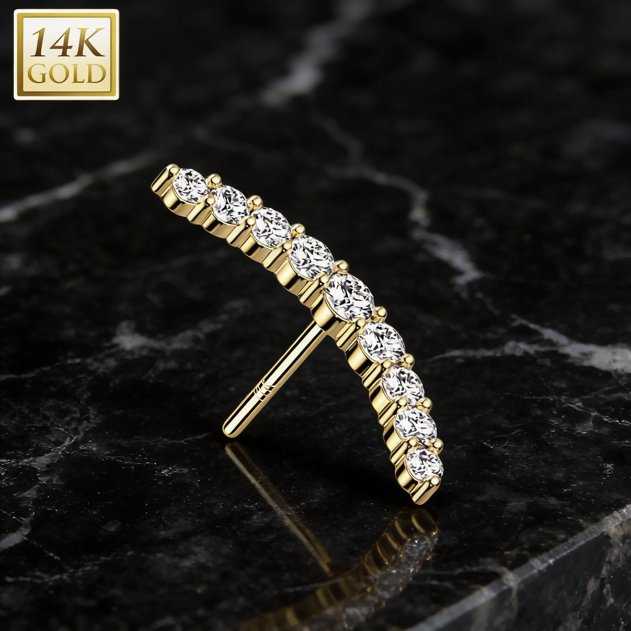 14k gold diamond barbell piercing with high-polish finish on black marble background