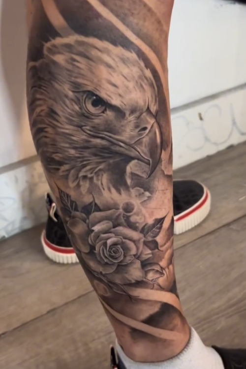 Black and grey eagle and rose realism tattoo by Ajay in Coral Springs