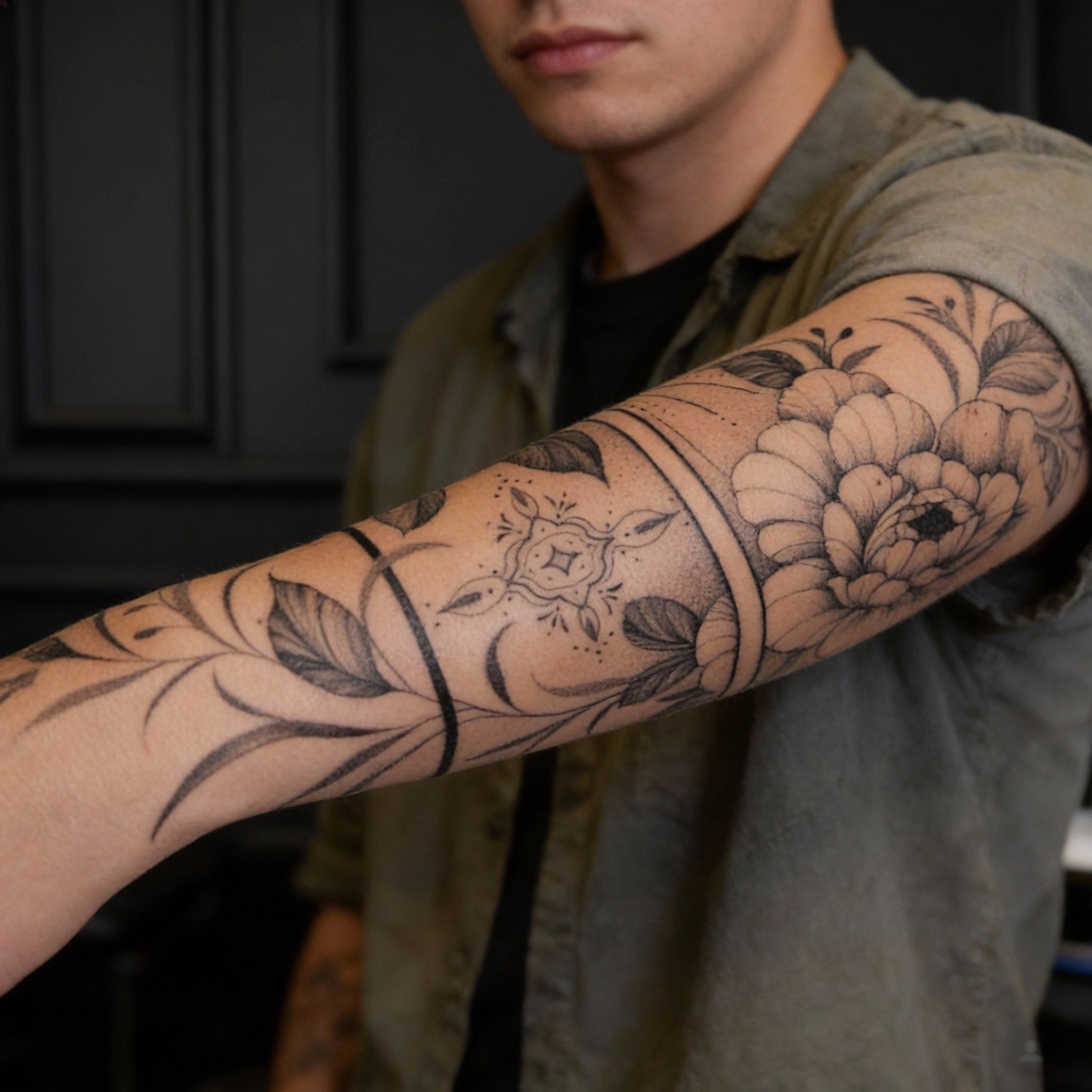 Fine line black and grey floral and ornamental forearm tattoo by a Coral Springs tattoo artist known for clean linework and detailed custom designs