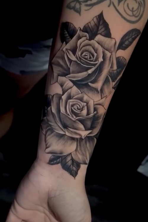 Black and grey realistic rose tattoo by Axel at Salvation Tattoo Lounge in Coral Springs