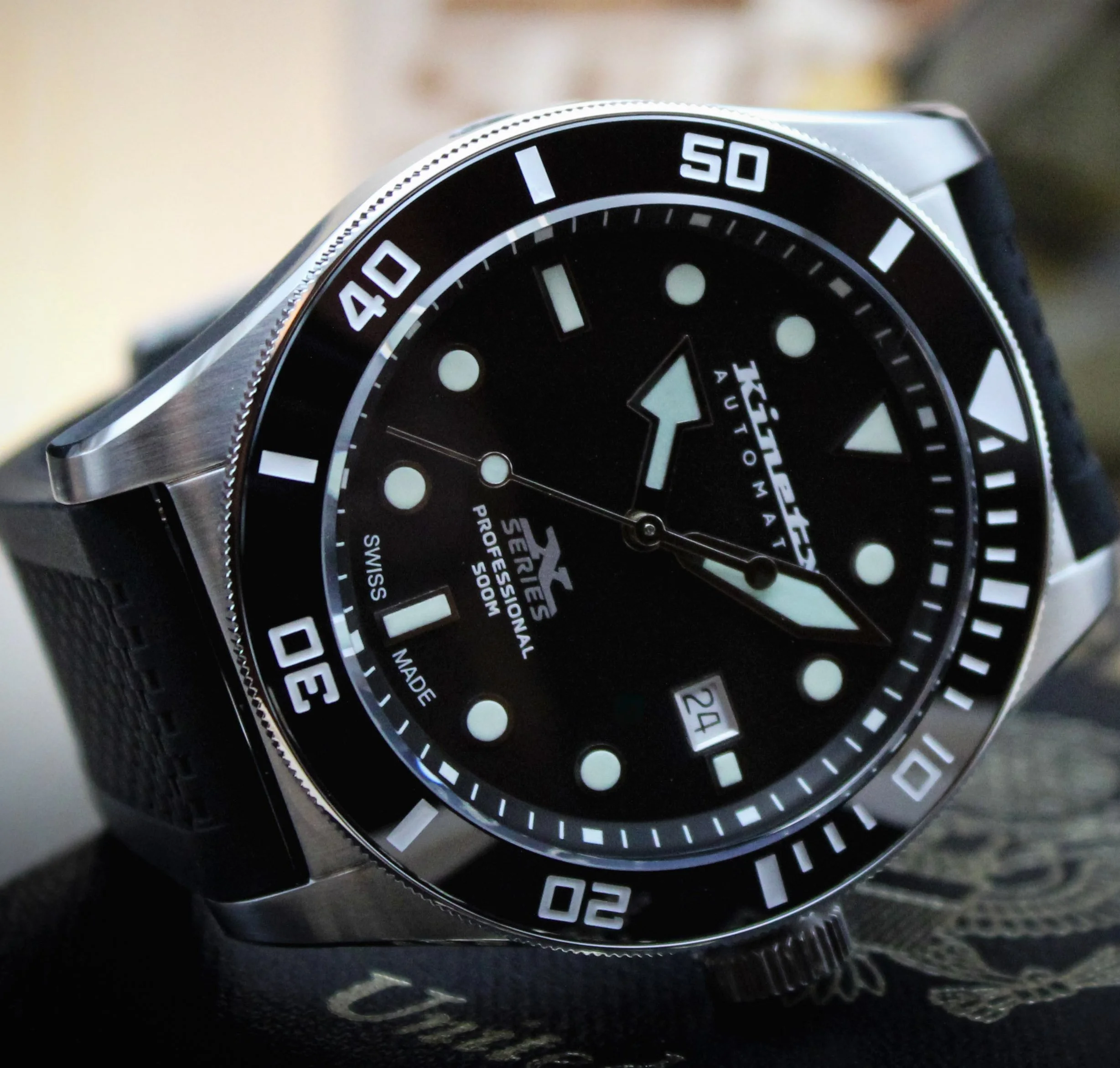 Diver's watch with black rubber strap.