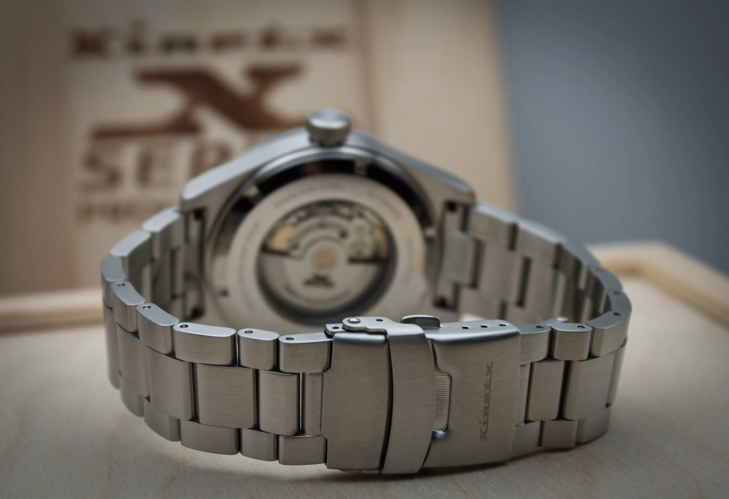 Stainless steel wristwatch with an engraved back.