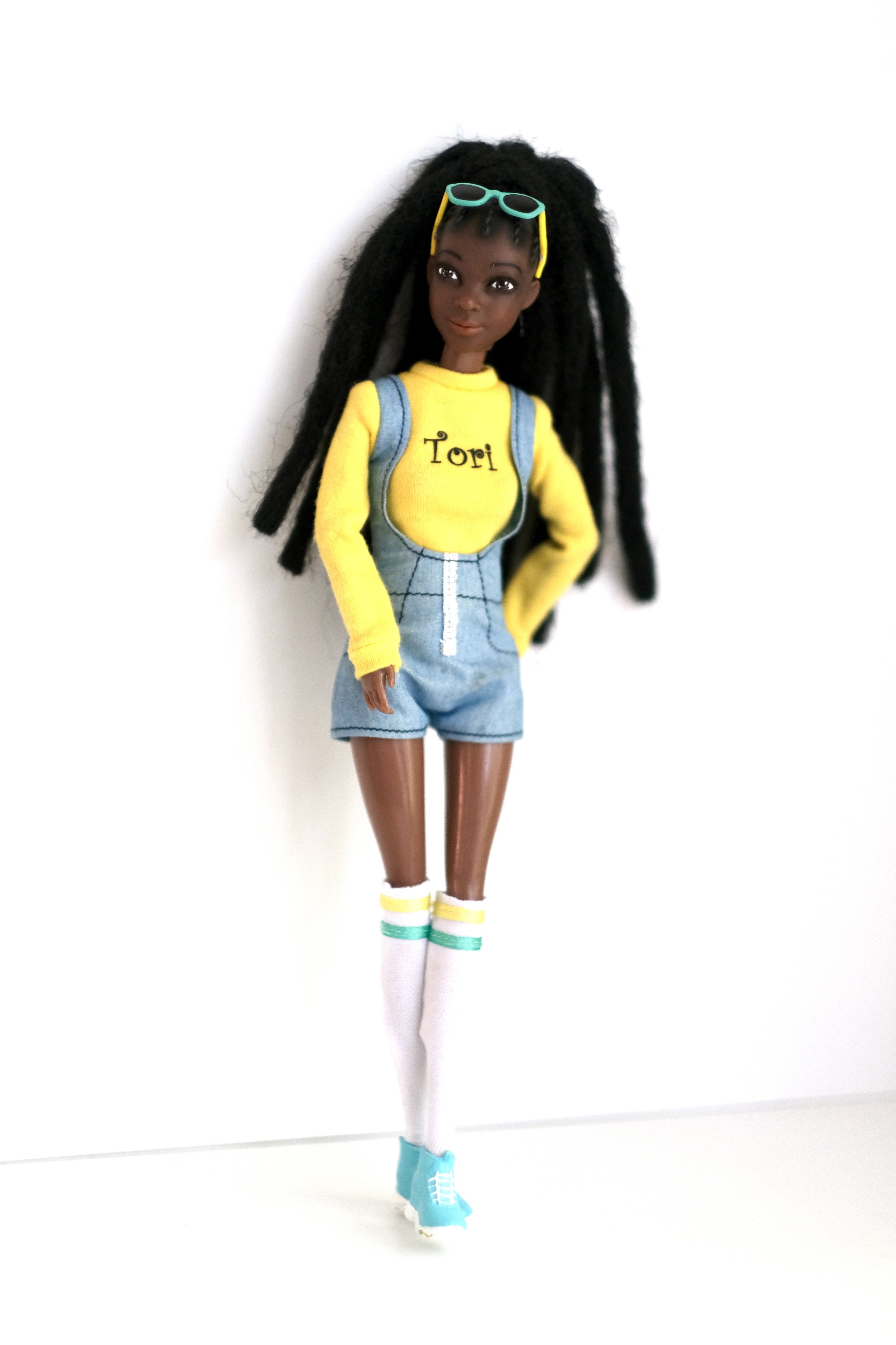 FUN - 
Tori Doll is all about bringing joy into playtime, with her vibrant personality and locs that are full of life. She’s a reminder that fun is found in being true to yourself and sharing laughter with others. When girls own a Tori Doll, they hol