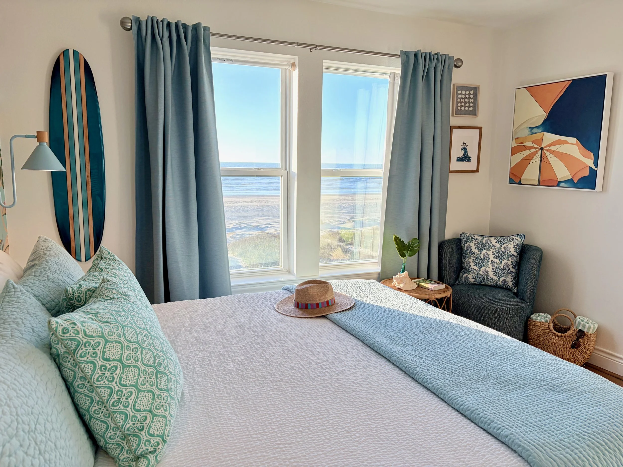 The upstairs oceanfront bedroom has a king bed, a Smart TV, and a comfortable reading chair for relaxing and taking in the views. 