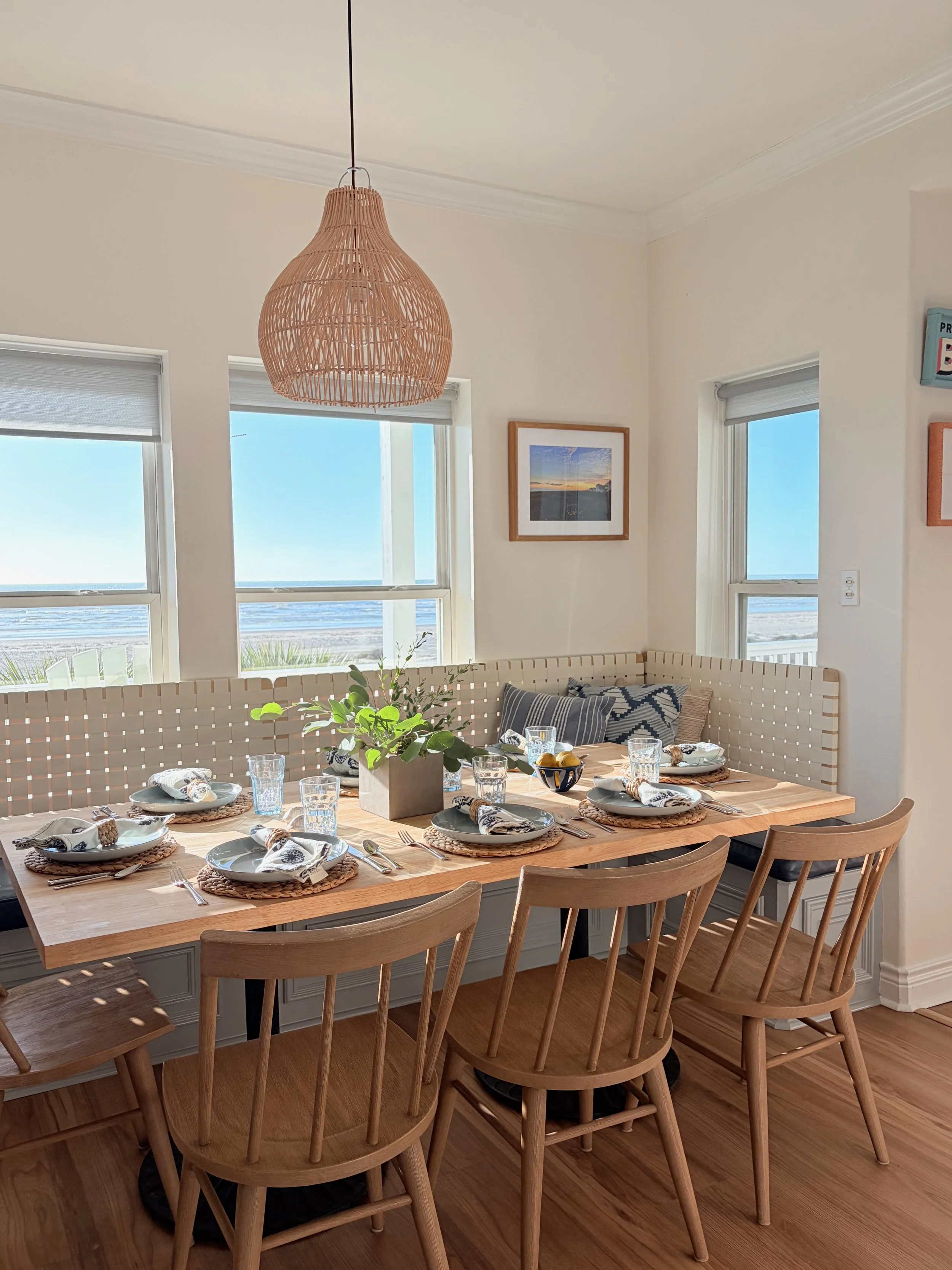 The kitchen flows into the dining area, featuring an island with seating for 4, banquette dining for 8, and additional seating in the living area for 4—ample room to host family meals. 