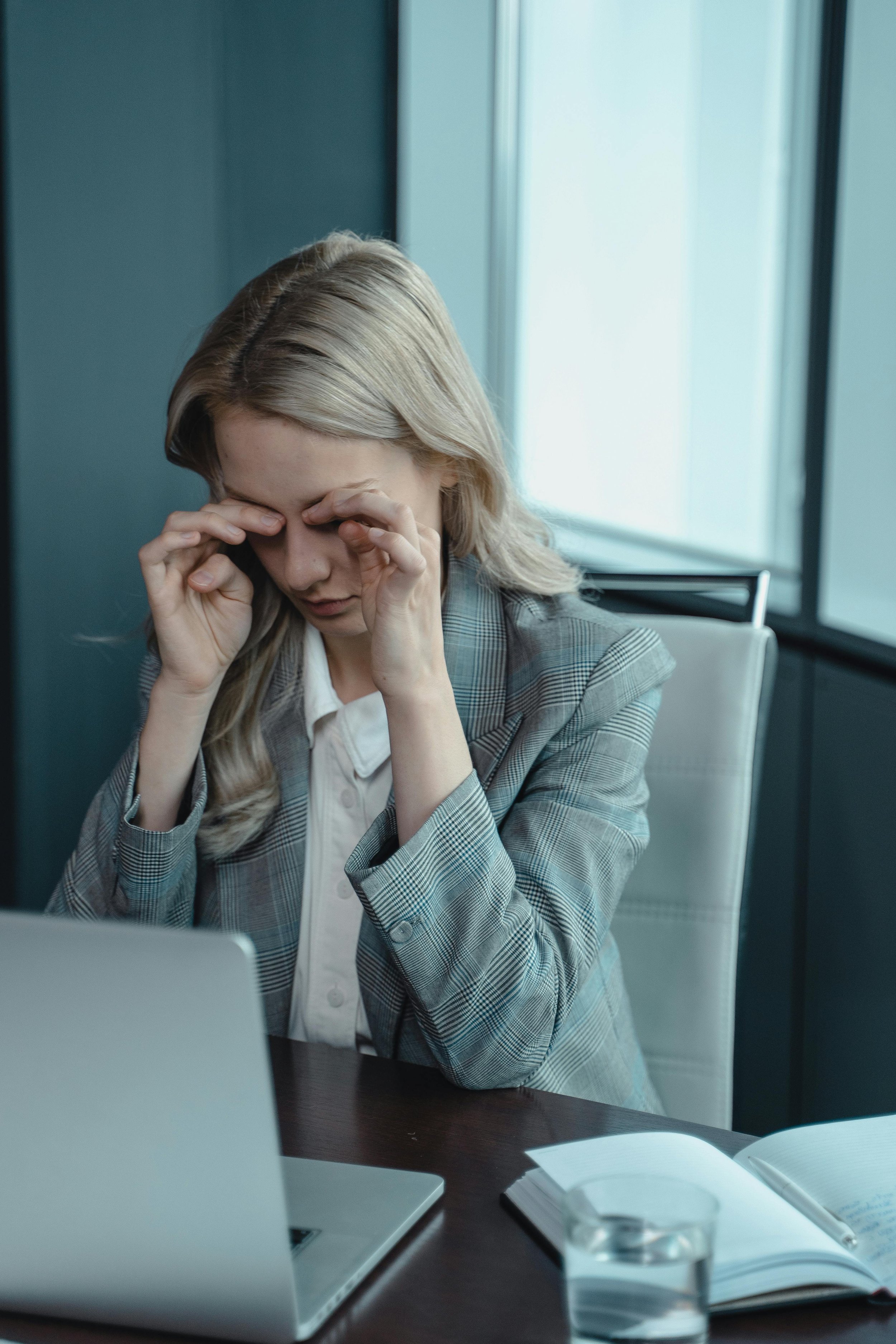 corporate worker focusing on computer screen, poor neck alignment, visual strain