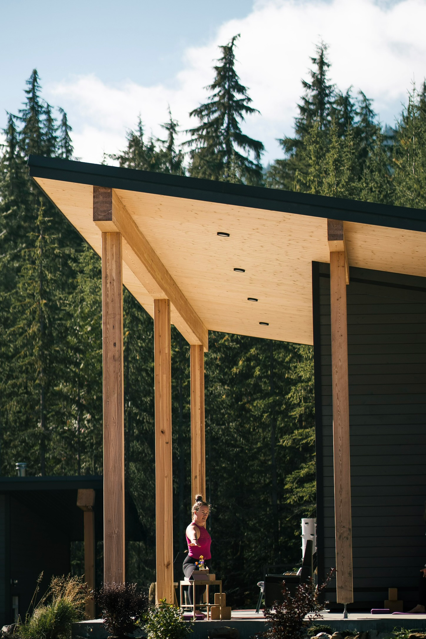 Modern timber cabin with CLT soffit and large timber post and beam porch, located in Shelter Bay BC. By TWO73 Designs – explore more.
