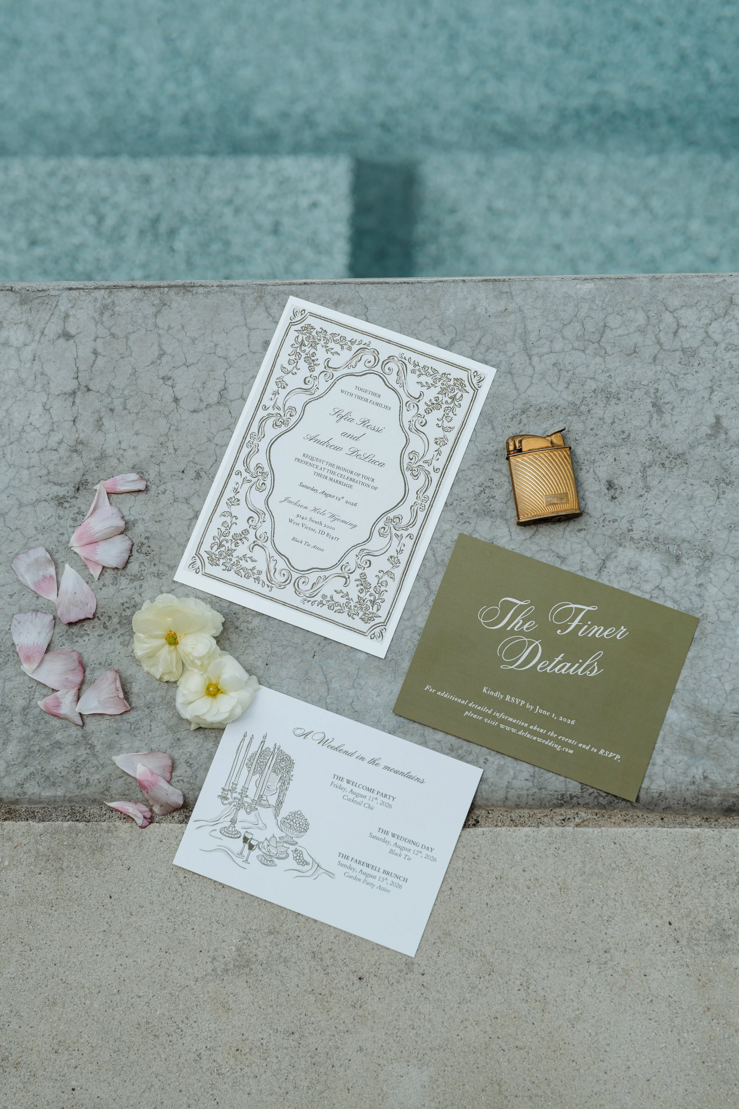 Close-up of wedding rings, one with a diamond, in velvet rings boxes, on a table with flower decorations and a wedding invitation.