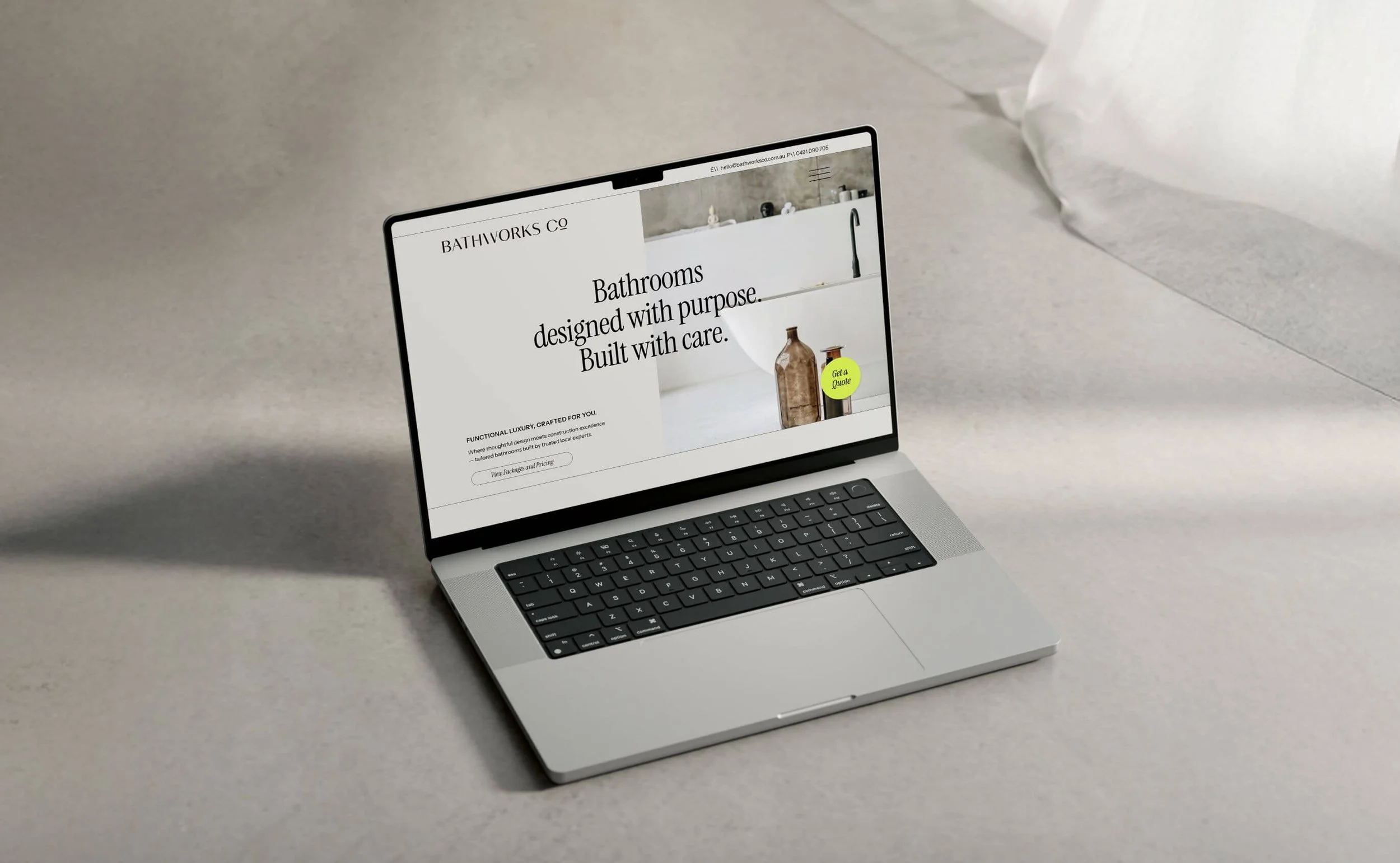 Laptop sitting on the floor with a white sheer curtain to the right.