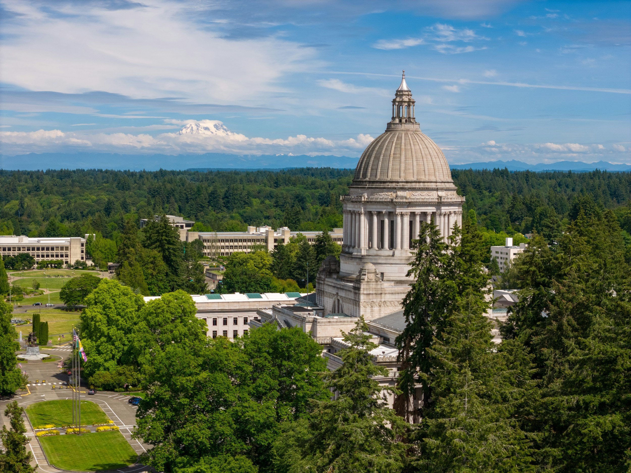A capitol building among green trees