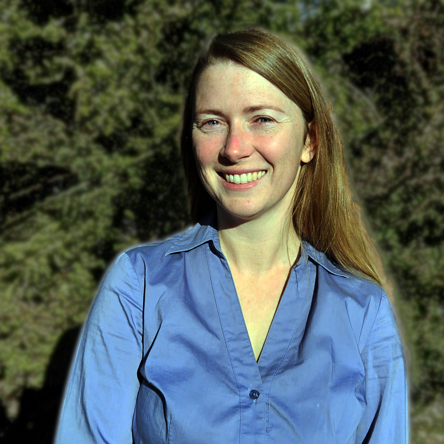 A woman in a blue shirt, against a green background