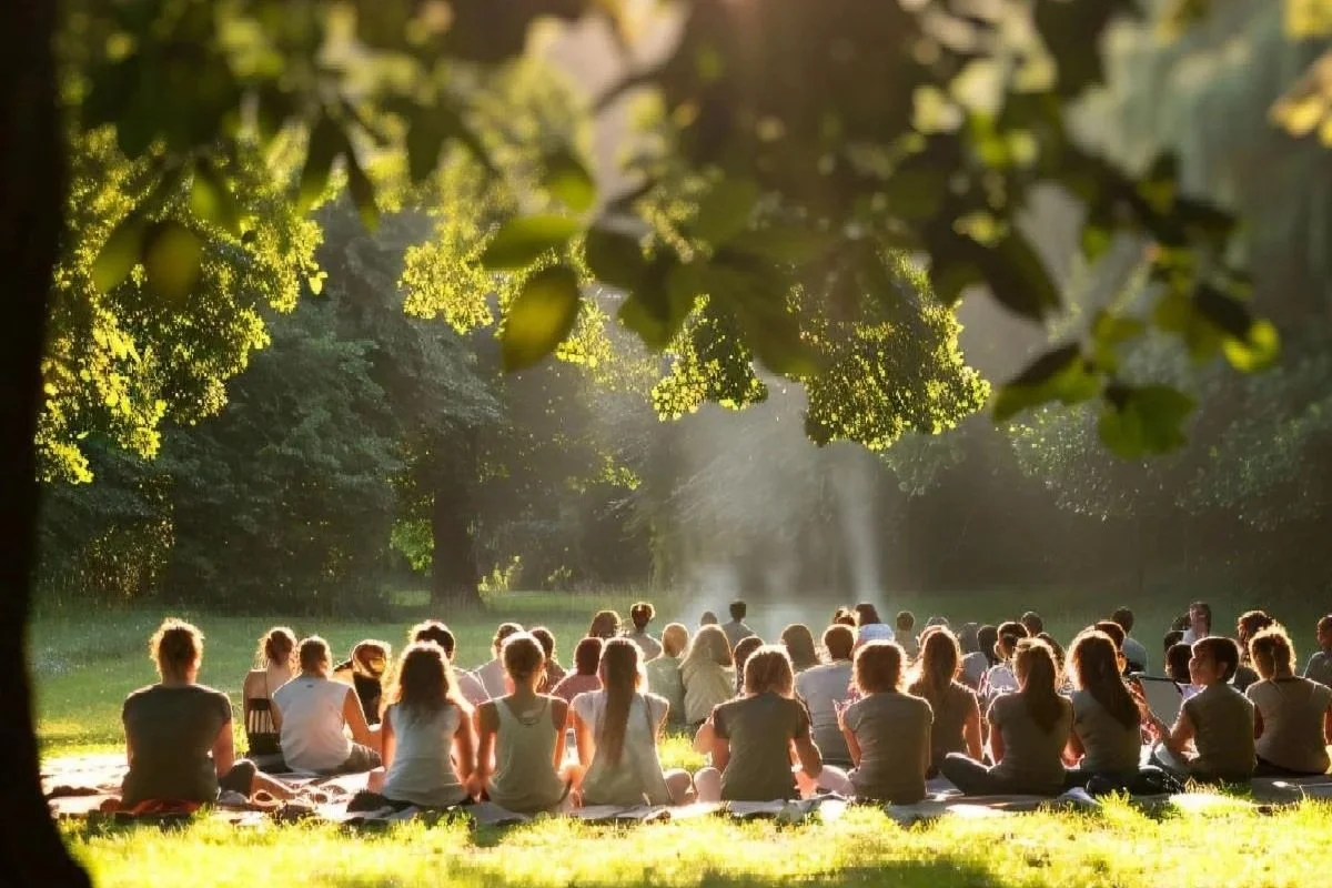 Group of people sitting outside in nature in a group setting