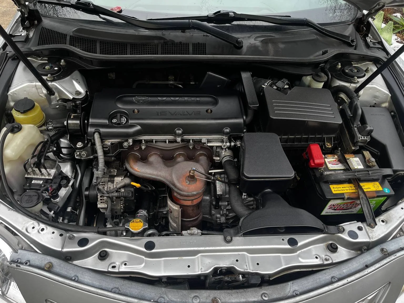Toyota Camry engine bay fully detailed after oil and coolant contamination cleanup by BryanzAutoDetailing.