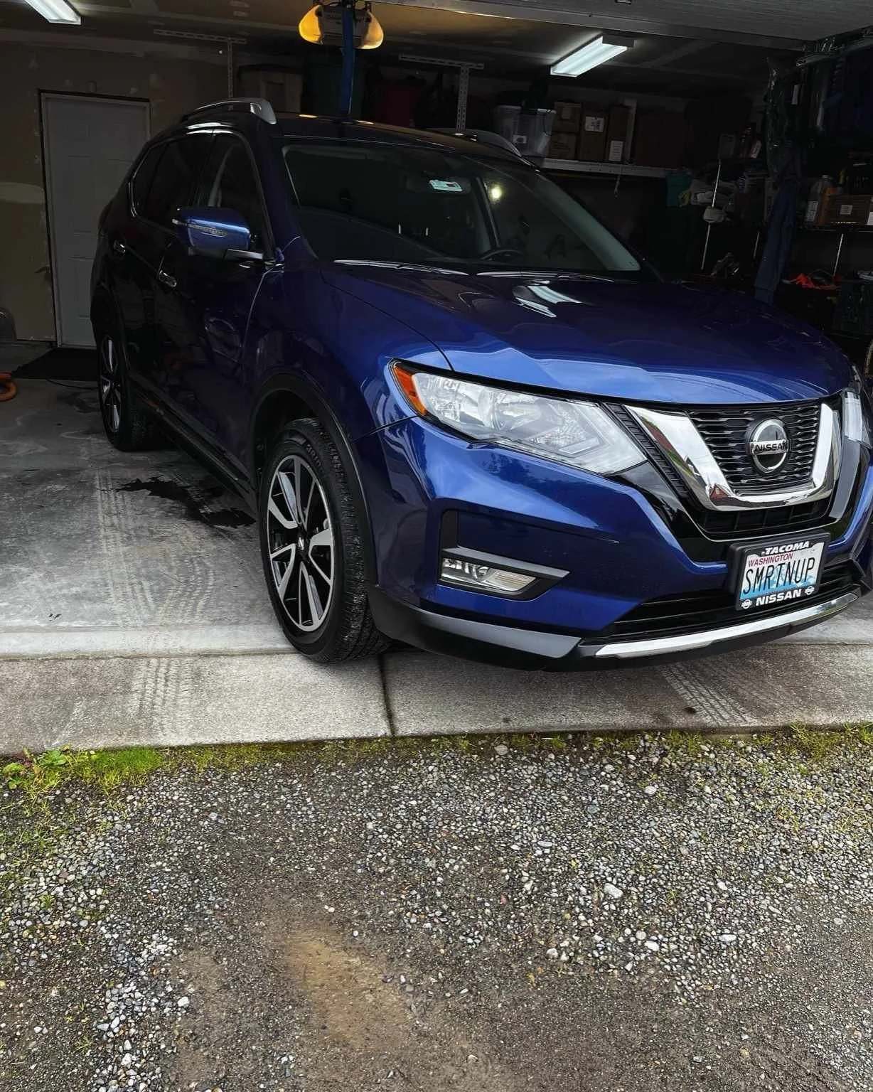 Blue Nissan Rogue after professional paint correction and polishing by Bryanz Auto Detailing, showing high-gloss reflections and swirl-free finish.