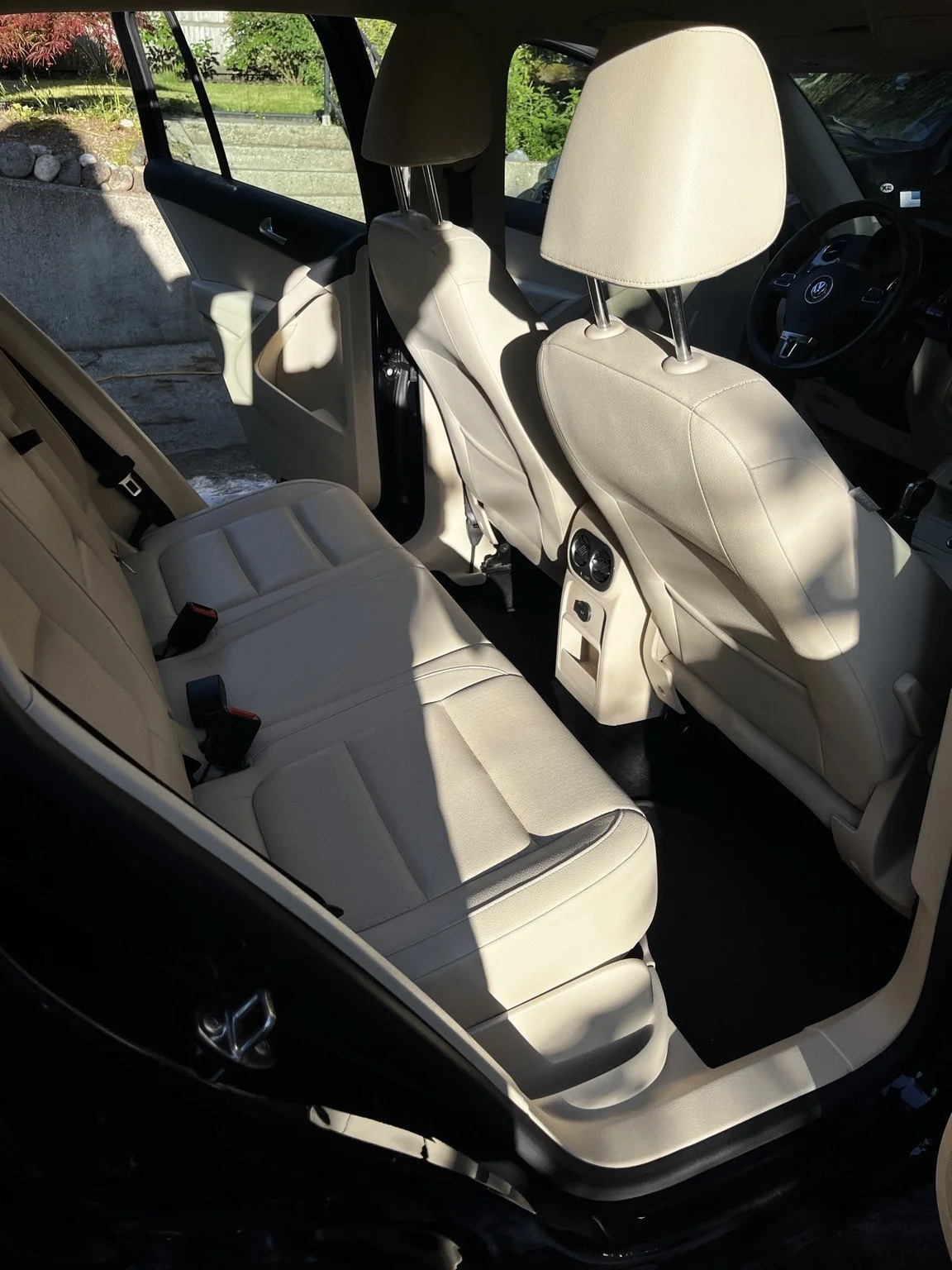 Volkswagen Tiguan rear passenger area after professional interior detailing in Tacoma WA featuring cleaned leather seats carpets and interior surfaces