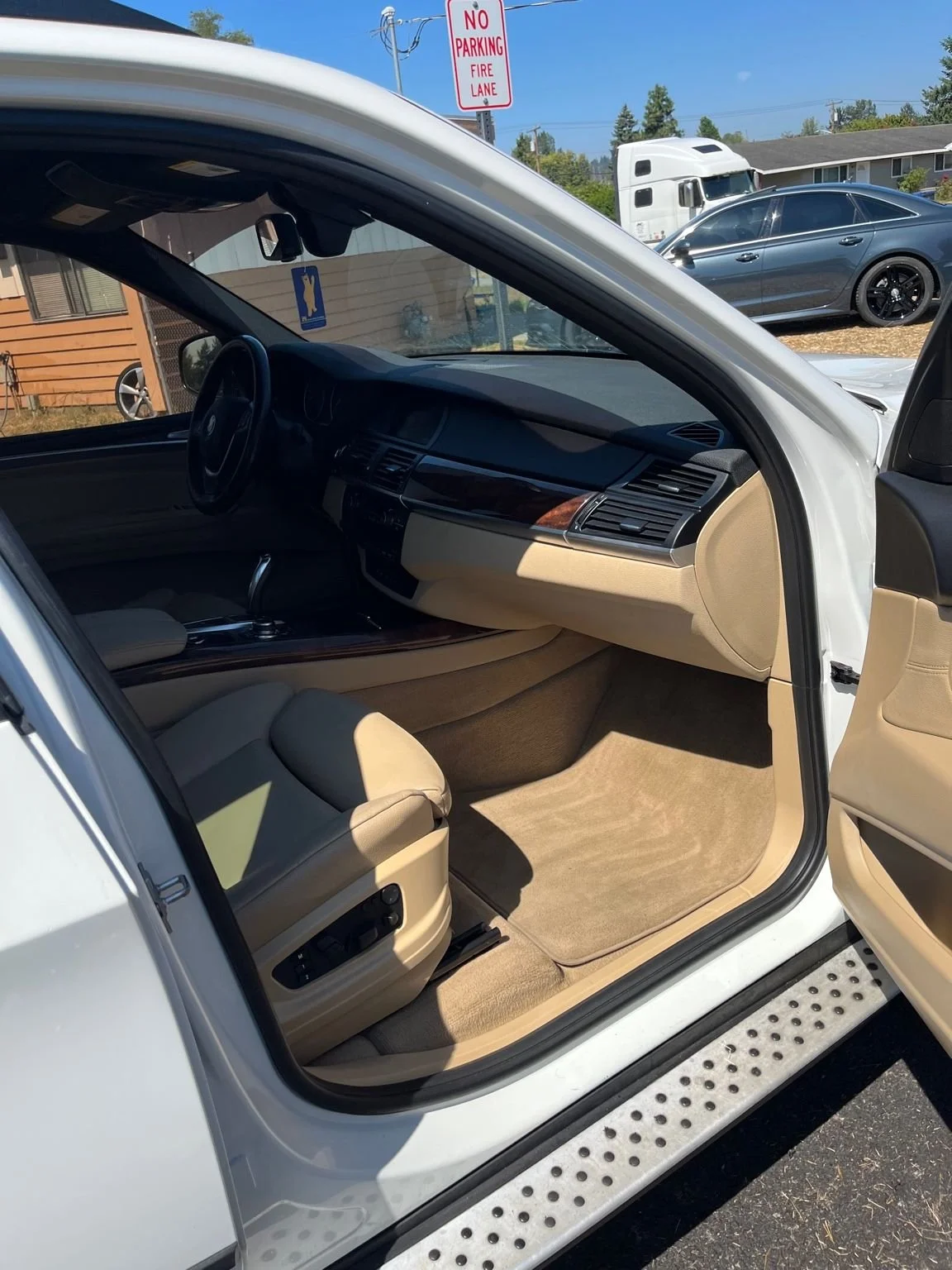 Professional BMW interior detailing in Graham, WA with restored tan leather seats and deep carpet cleaning.