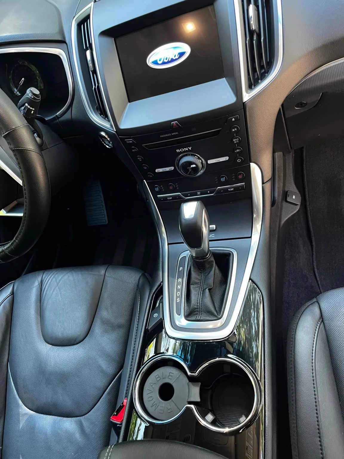 Ford Edge interior detail with deep cleaned leather seats, polished center console, and fully restored dashboard surfaces.