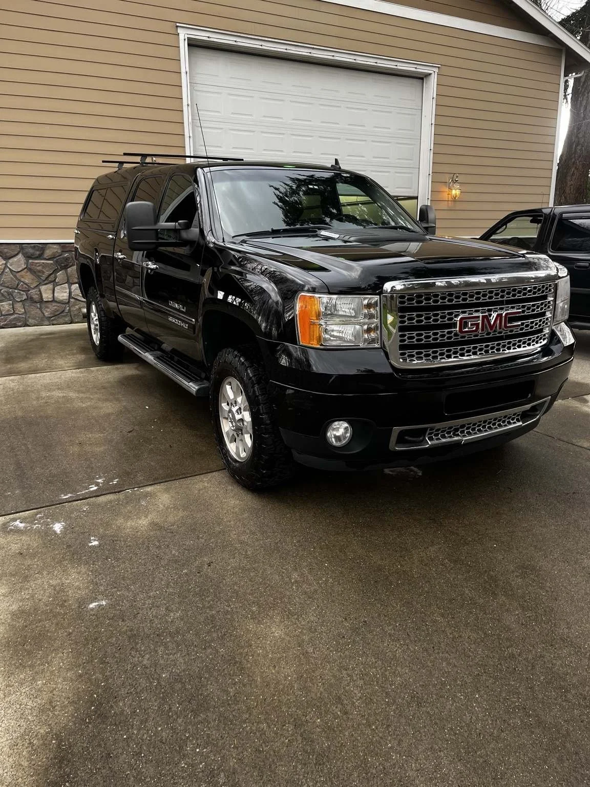 Glossy black GMC Sierra exterior after professional detailing by Bryanz Auto Detailing