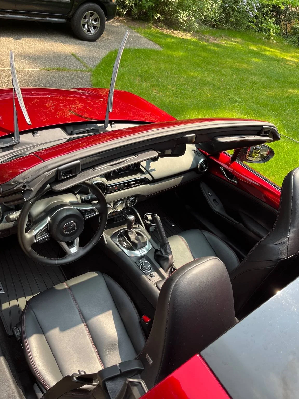 After mini interior detail on a Mazda MX-5 Miata with clean black leather seats and spotless dashboard, detailed by Bryanz Auto Detailing.