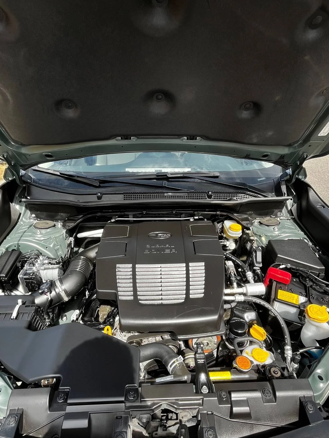 Engine Bay detailing on a Subaru Forester by BryanzAutoDetailing, showing a clean and shiny engine after a professional detail.