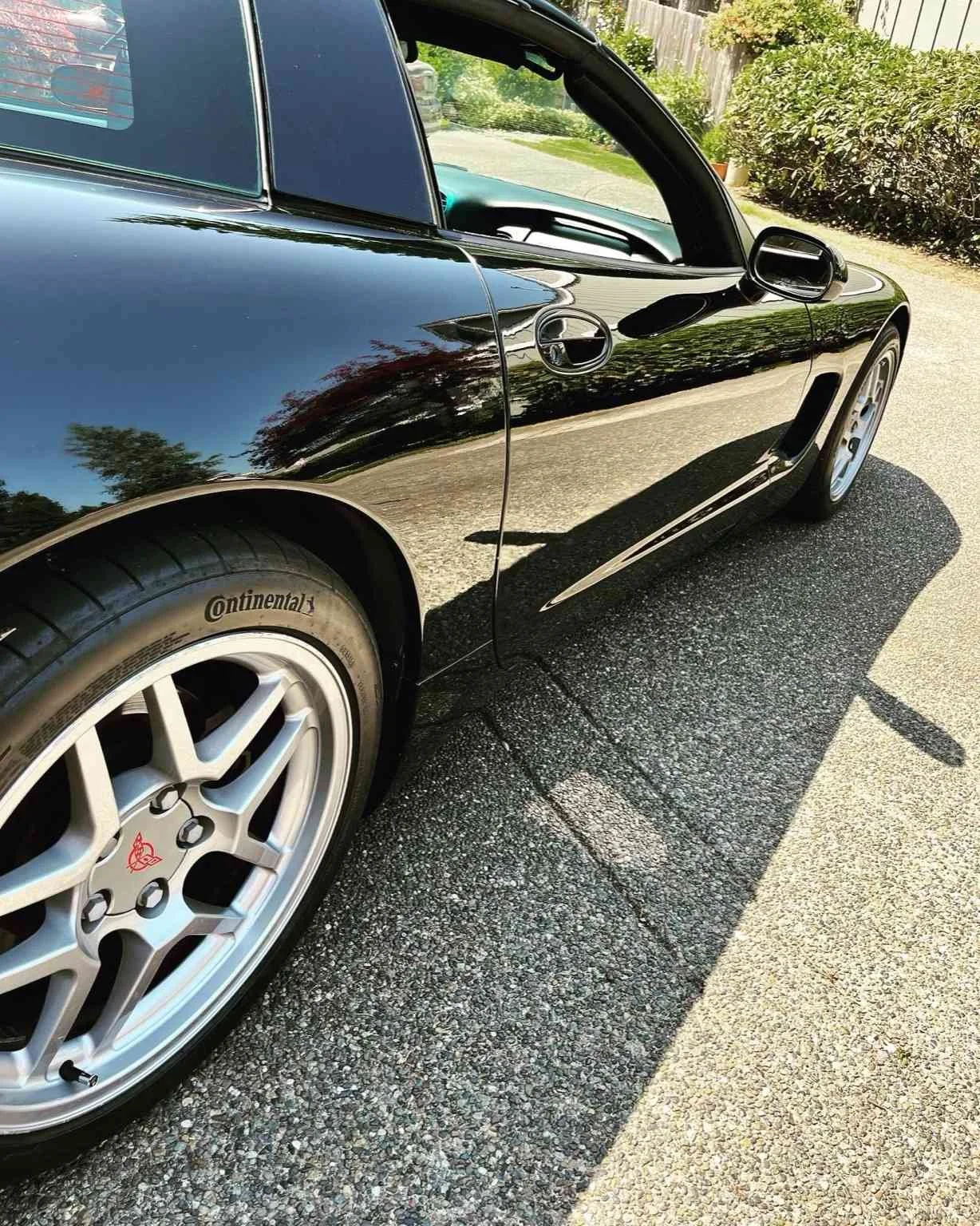 Black Chevrolet Corvette after professional paint correction by Bryanz Auto Detailing in Washington showcasing mirror reflection and swirl-free finish.