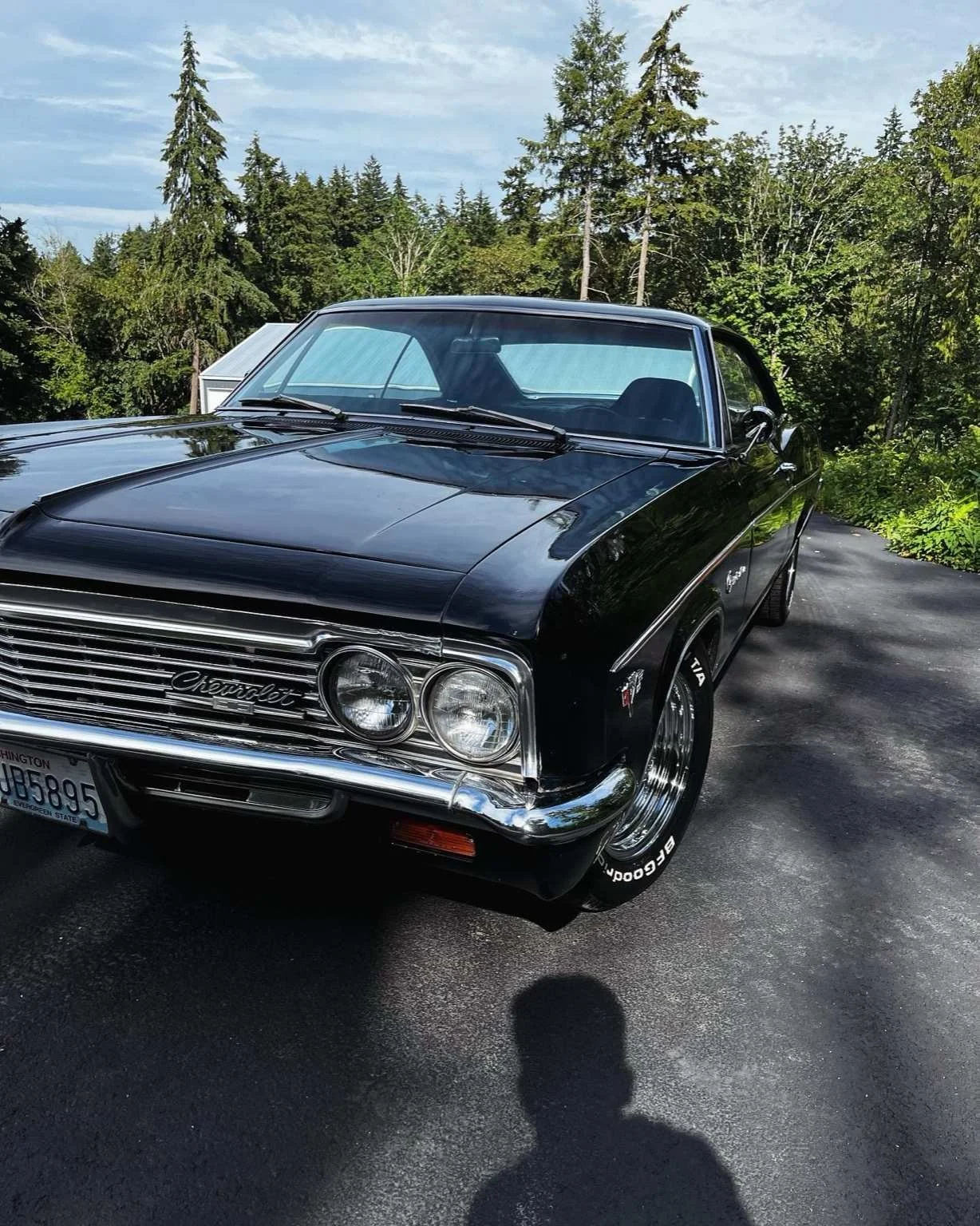 Black classic Chevrolet after full paint correction by Bryanz Auto Detailing in Washington, showing deep mirror gloss and swirl-free reflections.