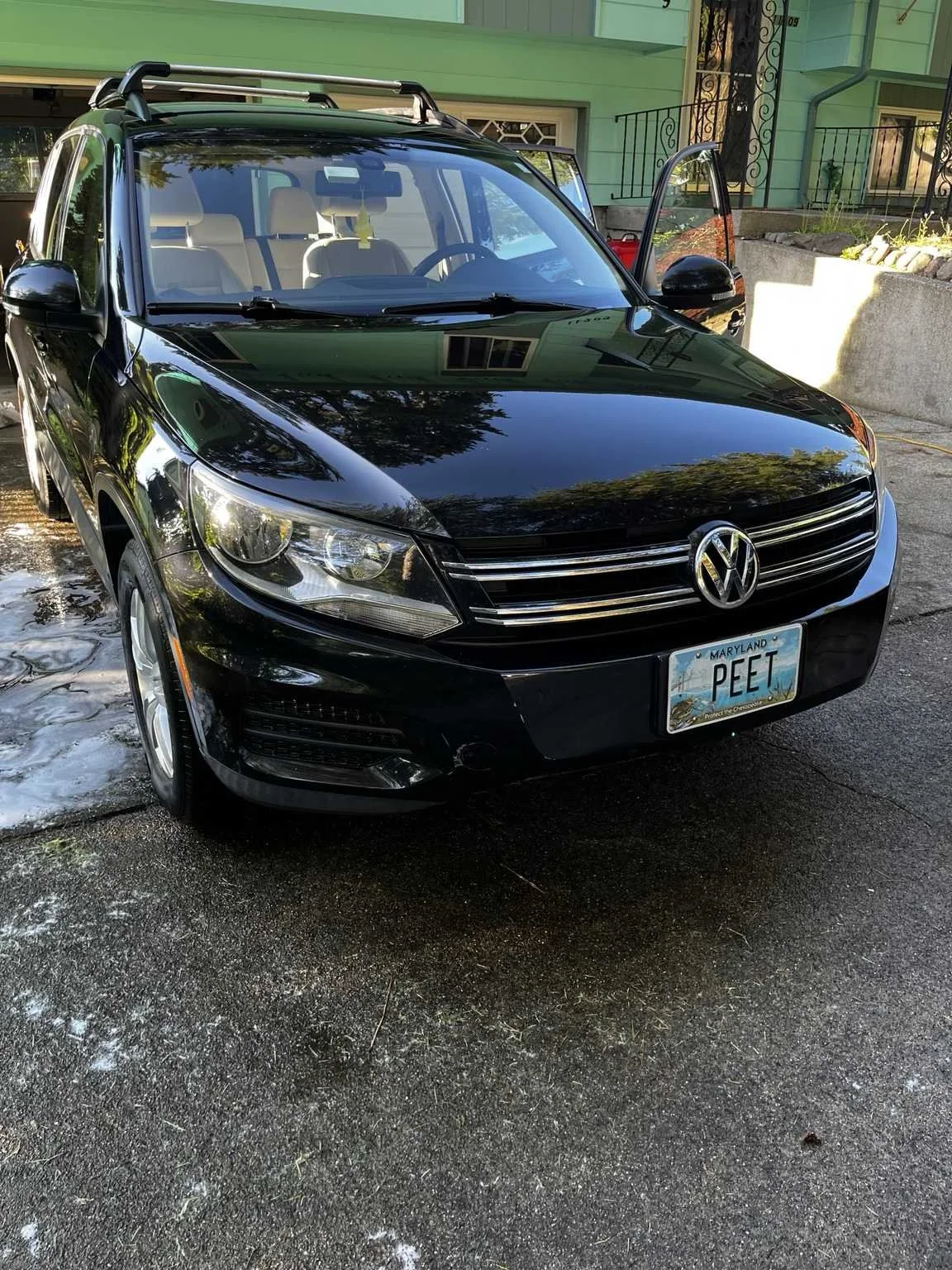 Black Volkswagen Tiguan after exterior detailing service in Tacoma WA with deep gloss shine clean paint and professionally detailed finish
