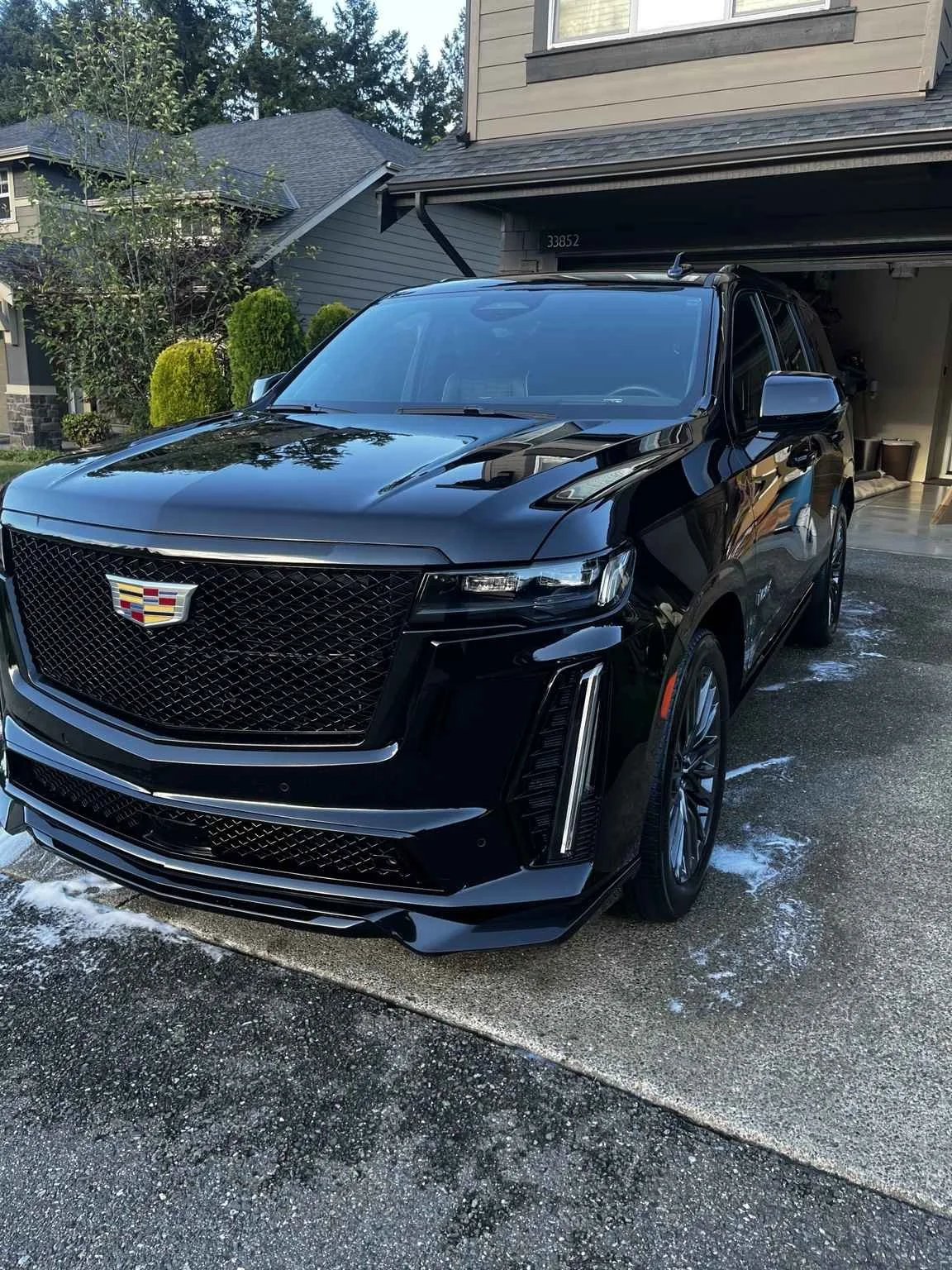Professional exterior detailing Bellevue Wa - black Cadillac SUV restored with high gloss finish by mobile detailing service.