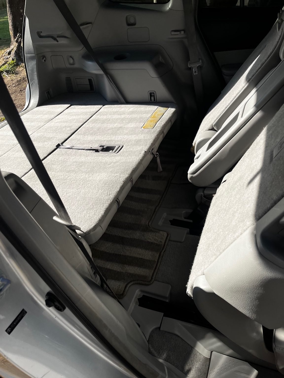 Full interior detail on a Toyota Highlander with folded seat cleaning, cargo area vacuuming, and carpet restoration.