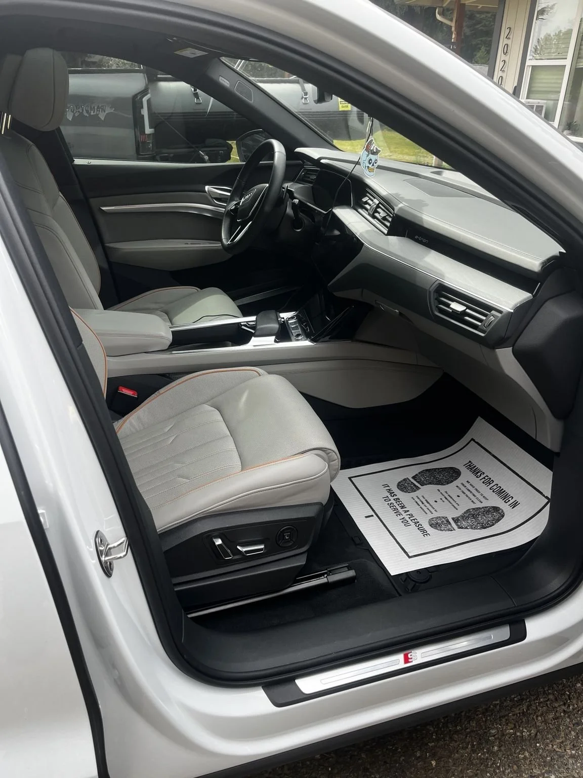 Audi e-tron front passenger interior after luxury mobile detailing service in Bonney Lake WA featuring spotless leather seats dashboard and floor cleaning by Bryanz Auto Detailing